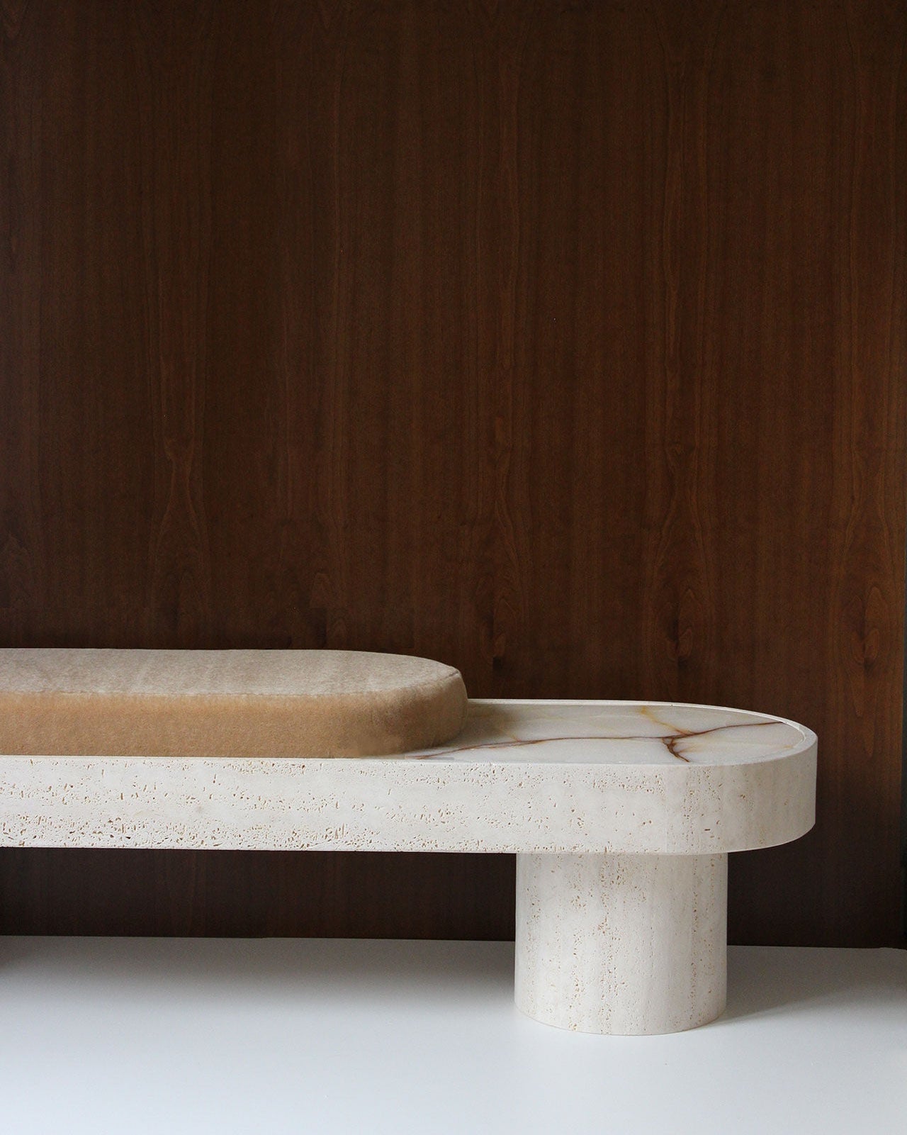 Noto Bench — top view of beige upholstered seat on stone base