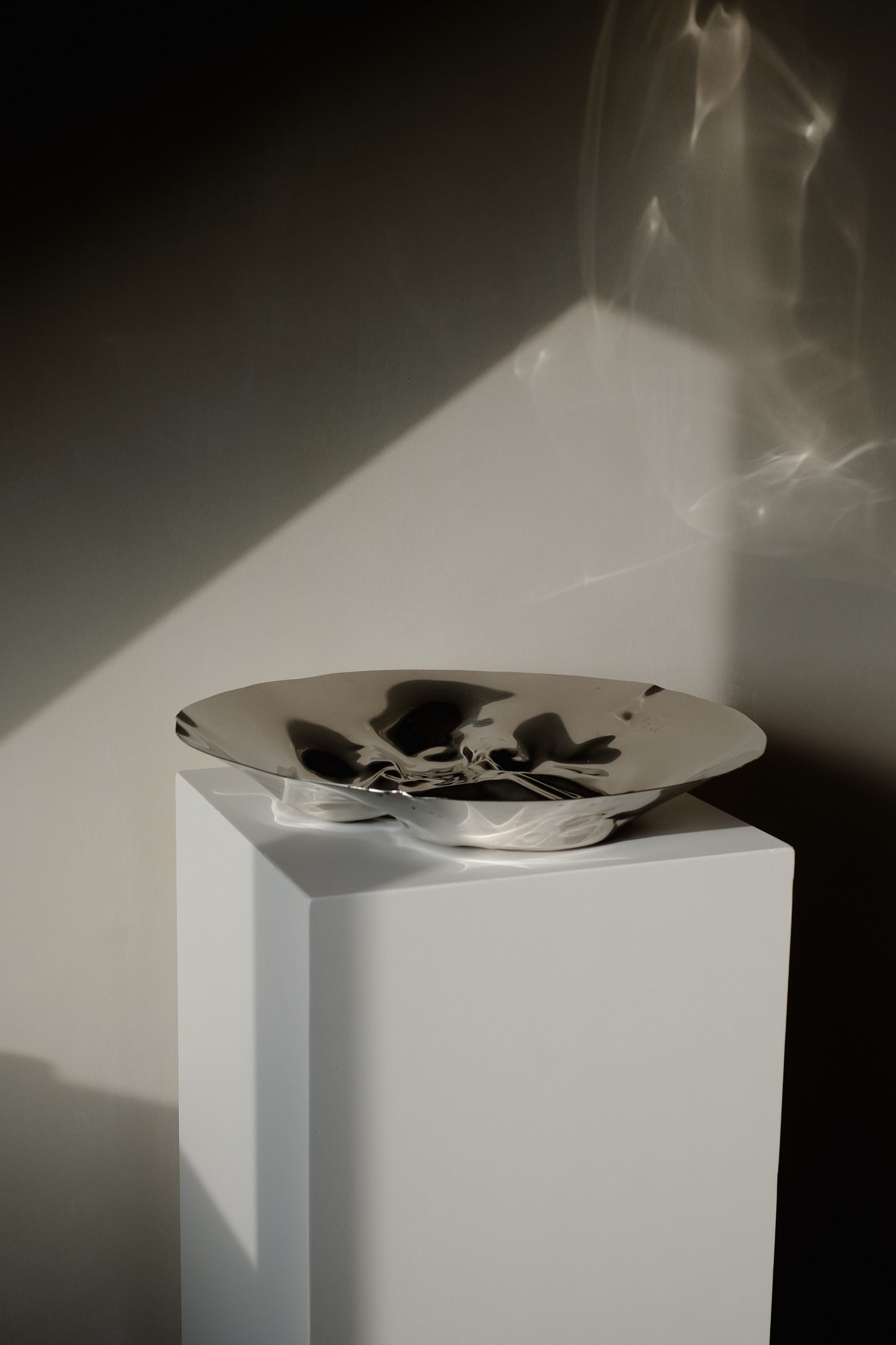 Chrome Curved Decorative Bowl — close-up of reflective chrome surface on pedestal