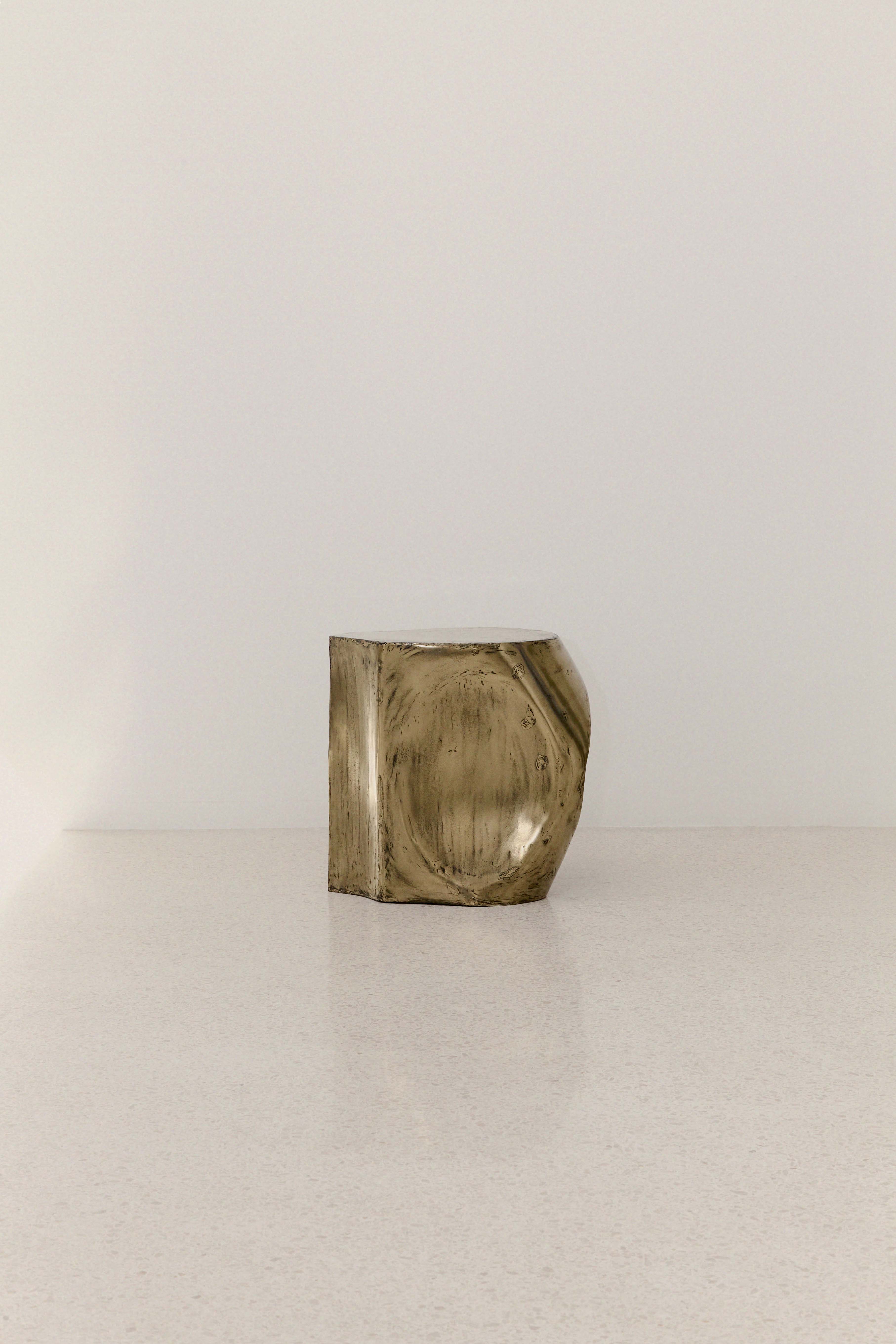 ROCHER SMALL TABLE IN POLISHED BRASS RESIN — back view on light surface