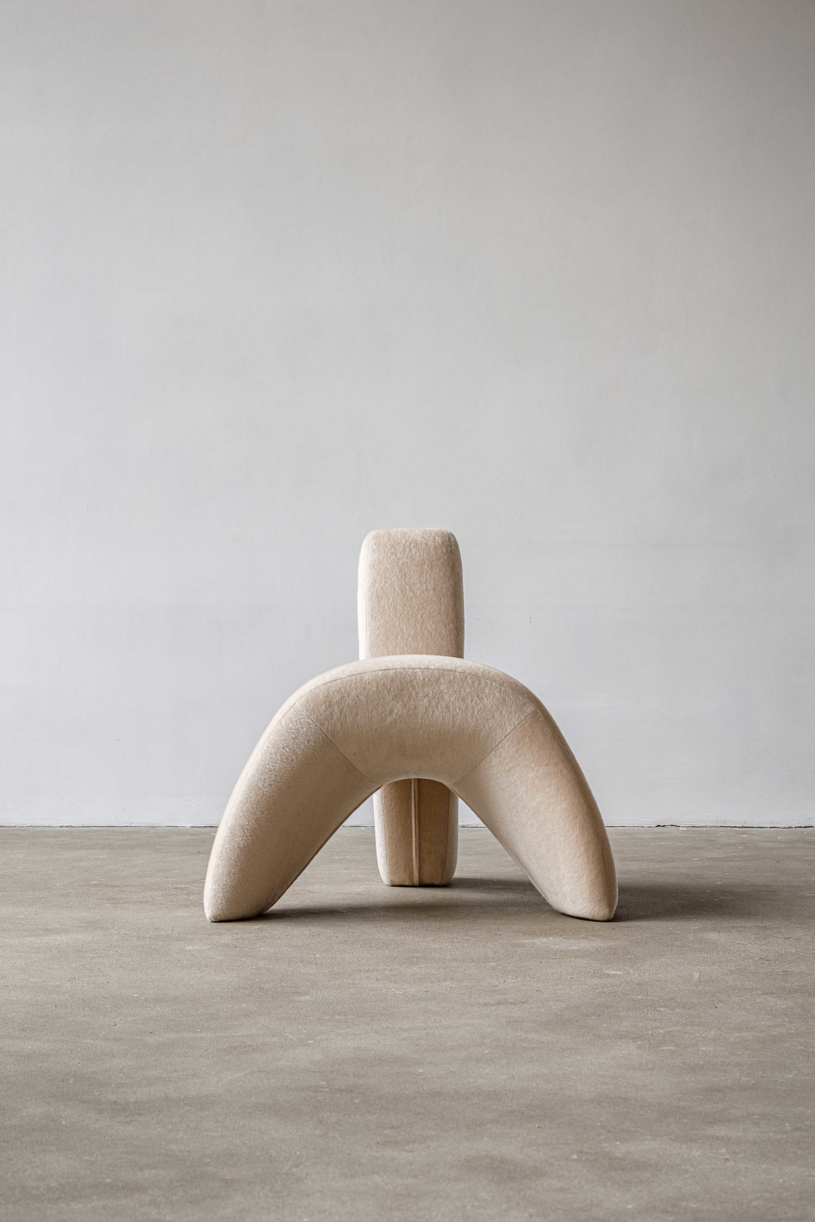 Sokil armchair — side angle showing soft beige upholstery