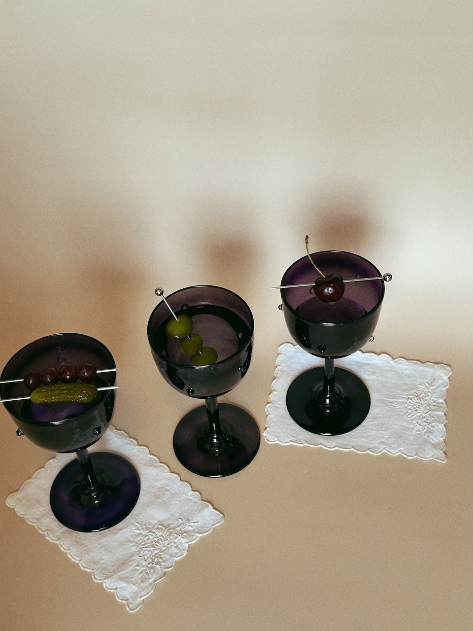 NOA GOBLET cocktail Glass — top view with dark glass and garnishes
