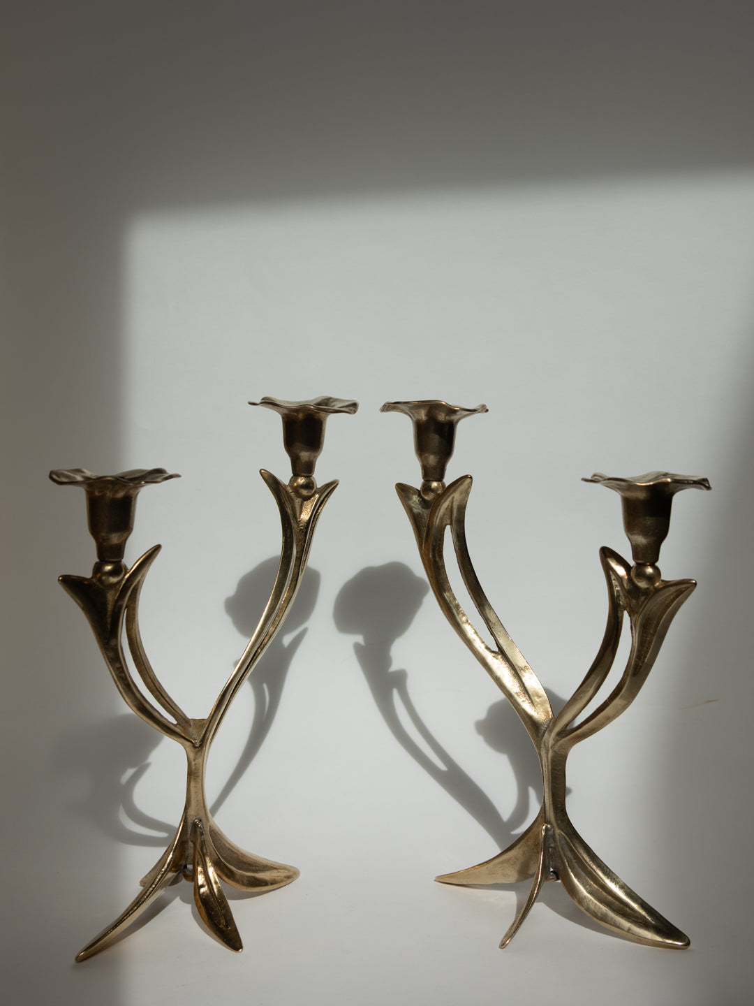 Pair of Sculptural Solid Brass Candlesticks, Floral Form - France, c. 1960s — side angle highlighting floral design and brass