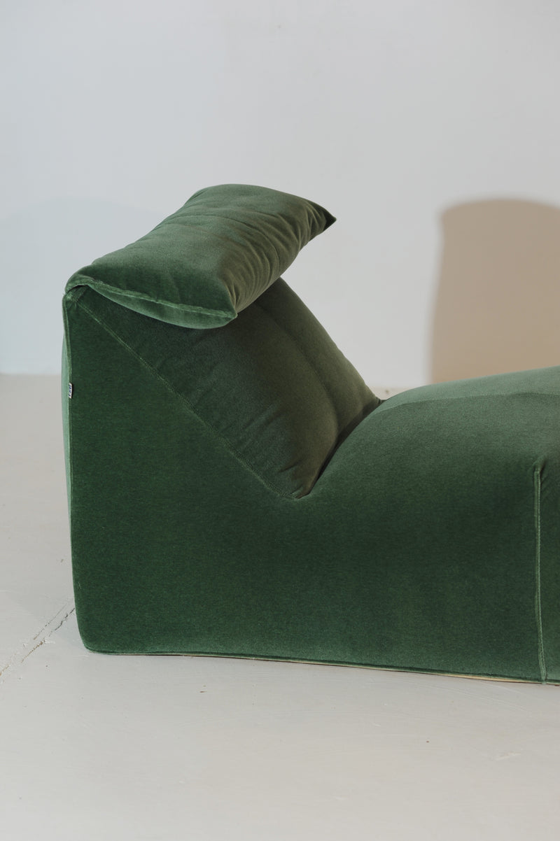 Detail view of Le Bambole green velvet chaise lounge armrest