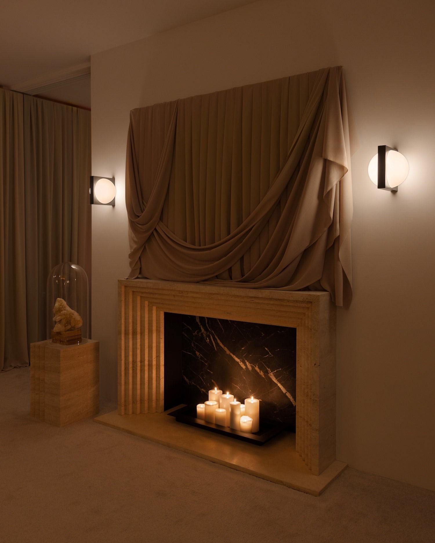 Solstice Wall Light — installed on wall beside draped fabric