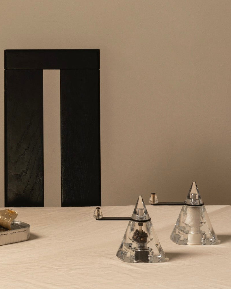 Vintage Modernist Pepper & Salt in Acrylic Glass — close-up on dining table with black chair