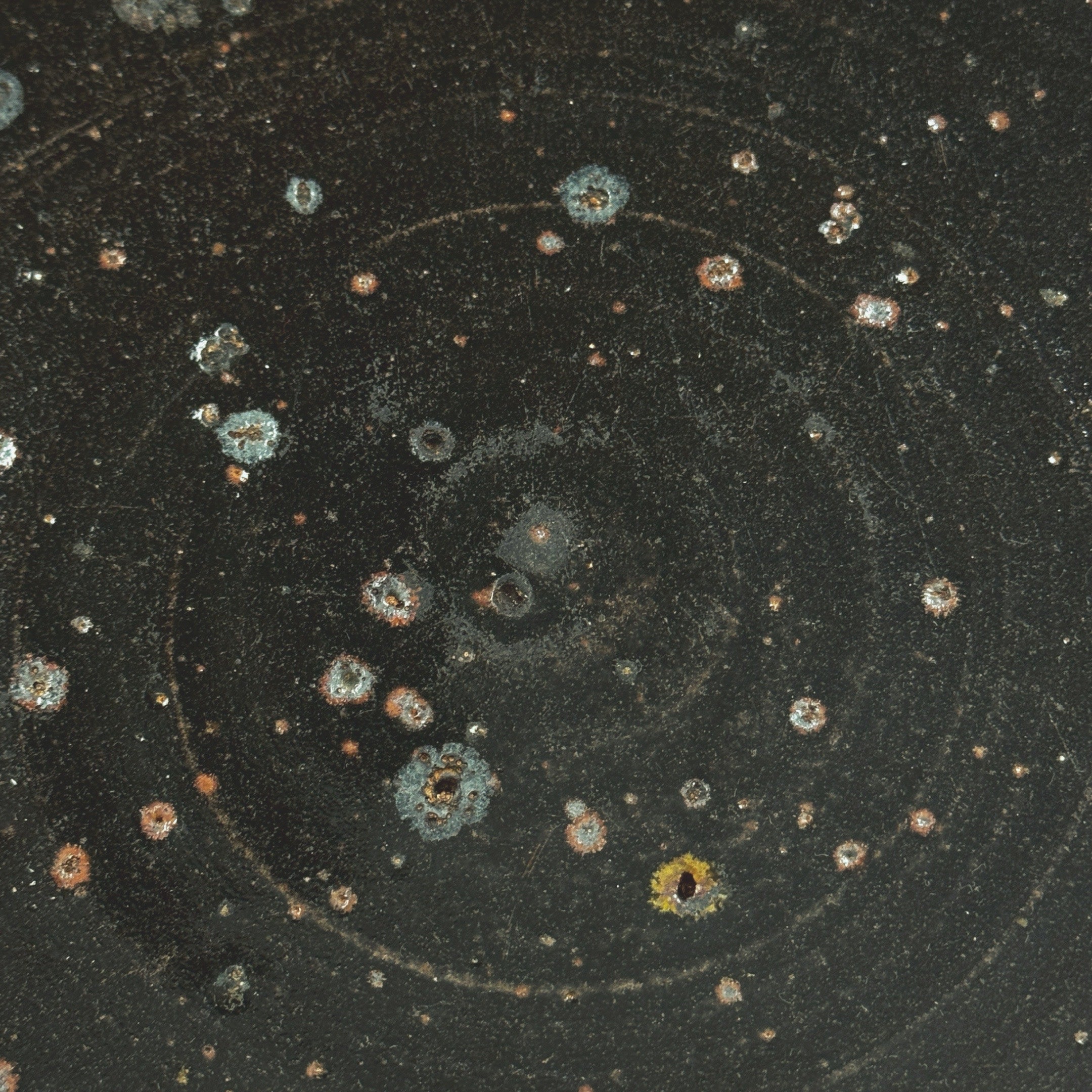 Close-up detail of glazed stoneware bowl surface with circular motifs
