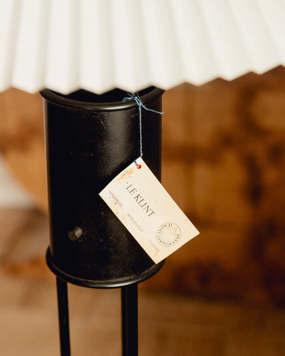 Le Klint Floor Lamp — close-up of black metal base with tag