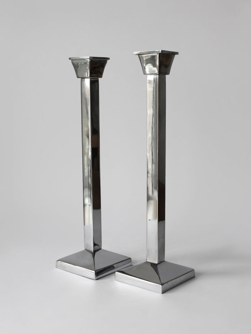 Pair Of Polished Mirror Metal Tall Candle Holders — close-up of shiny metal finish