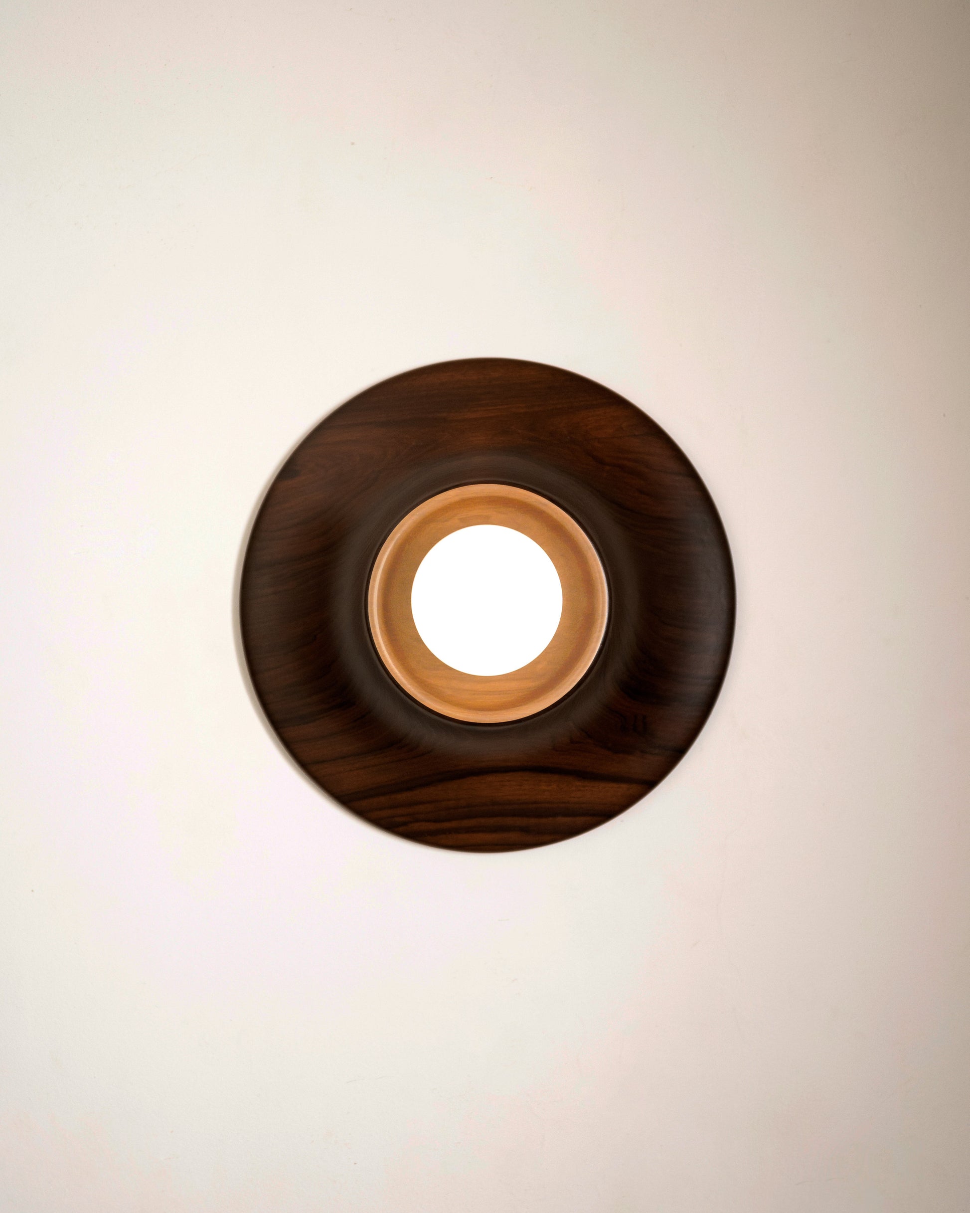 Paten Wall Light — close-up of round wooden frame with light