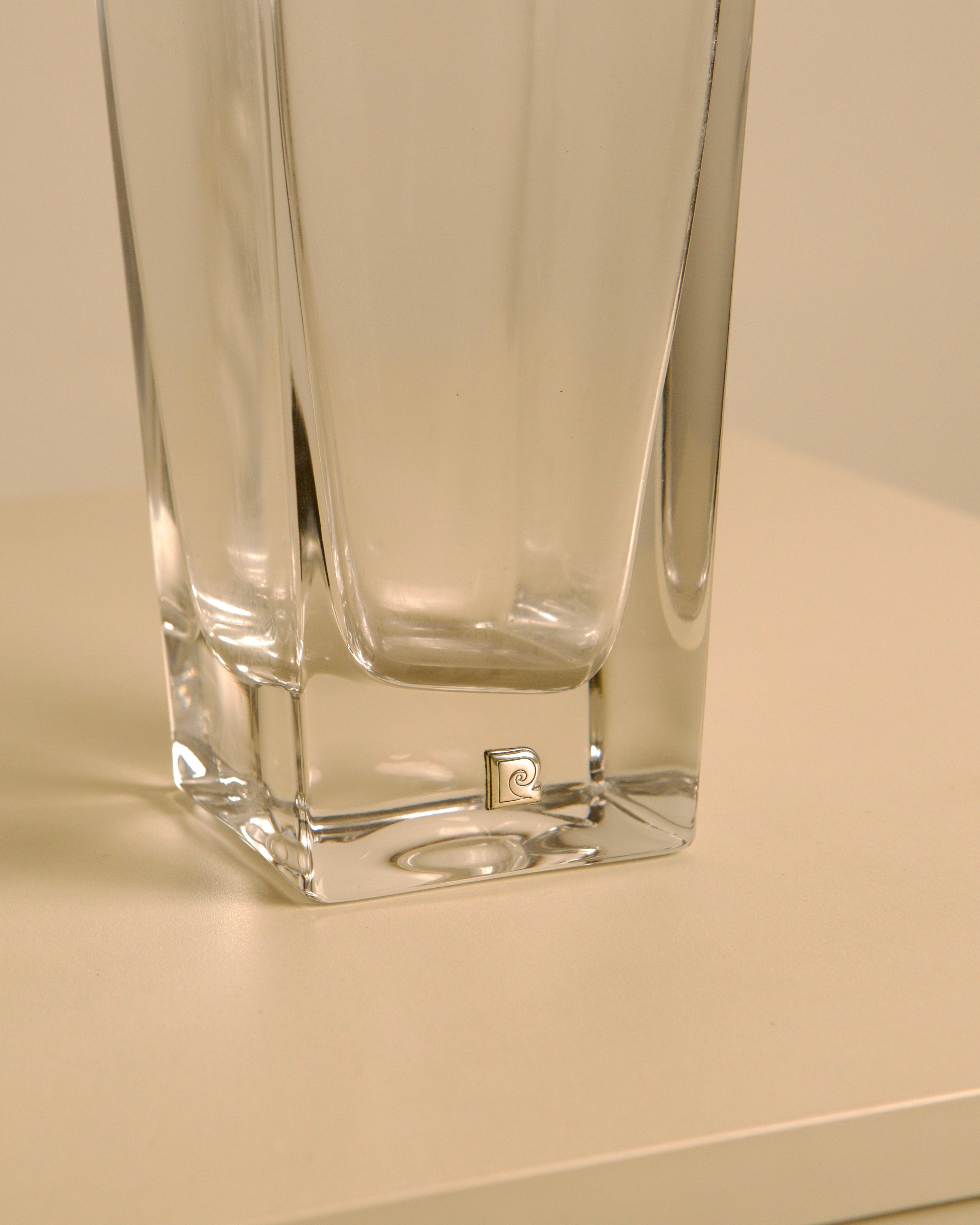 Glass vase with metal details by Pierre Cardin, 1980s — side angle showing clear glass and metal logo