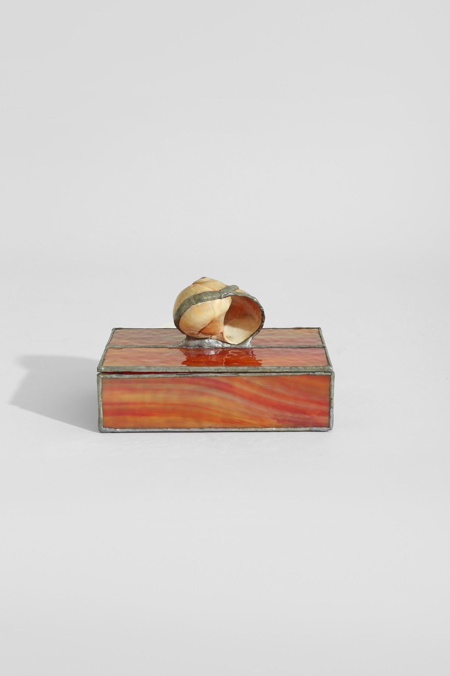 Spiral Shell Glass Jewelry Box — top view highlighting orange glass and shell detail