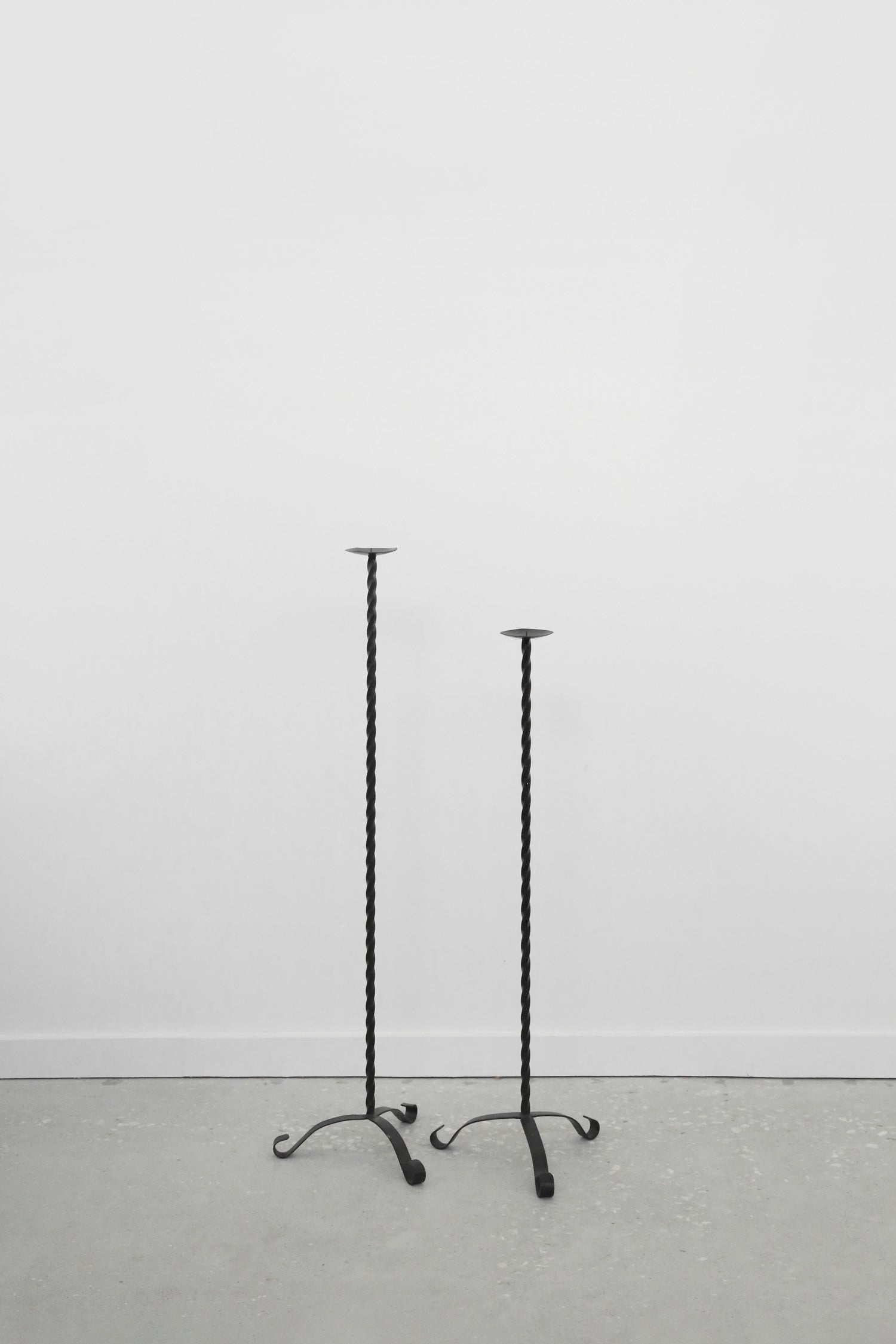Twisted Iron Floor Candleholder Set — side angle on concrete floor