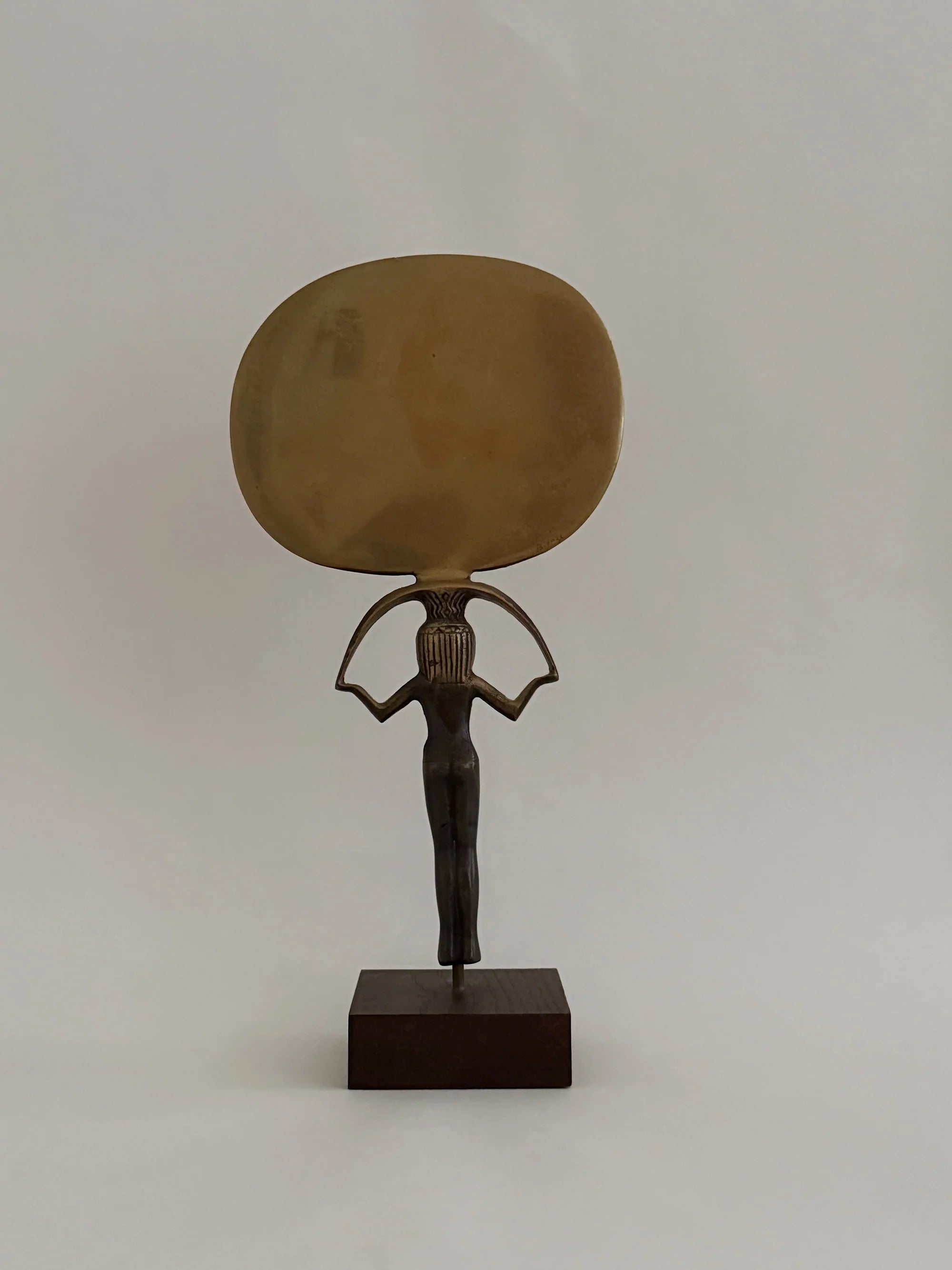 Bronze Sculpture of Isis Holding a Mirror — top view highlighting reflective surface