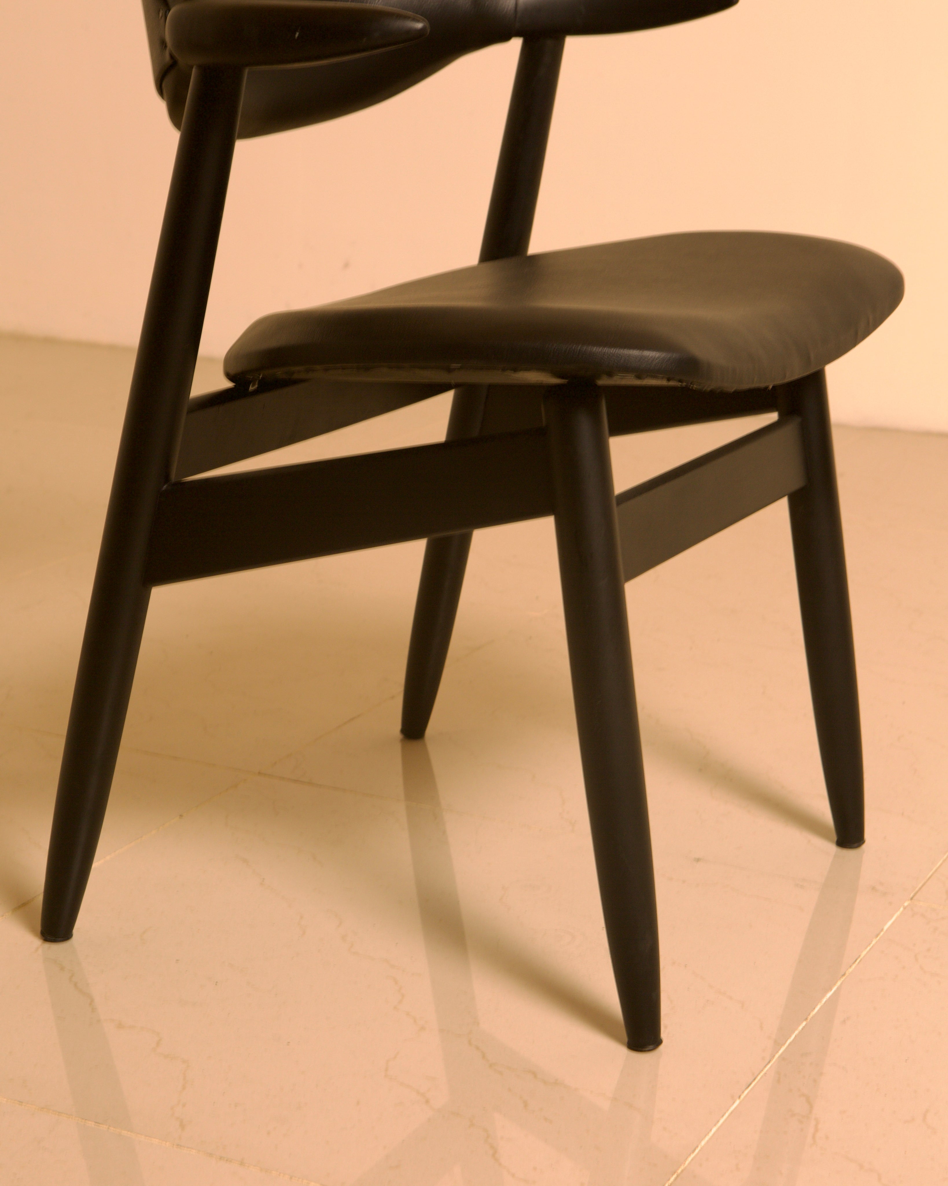 Dutch "Buffalo" Armchair in Wood and Black leather, 1960s — angled view highlighting black leather seat and wooden legs
