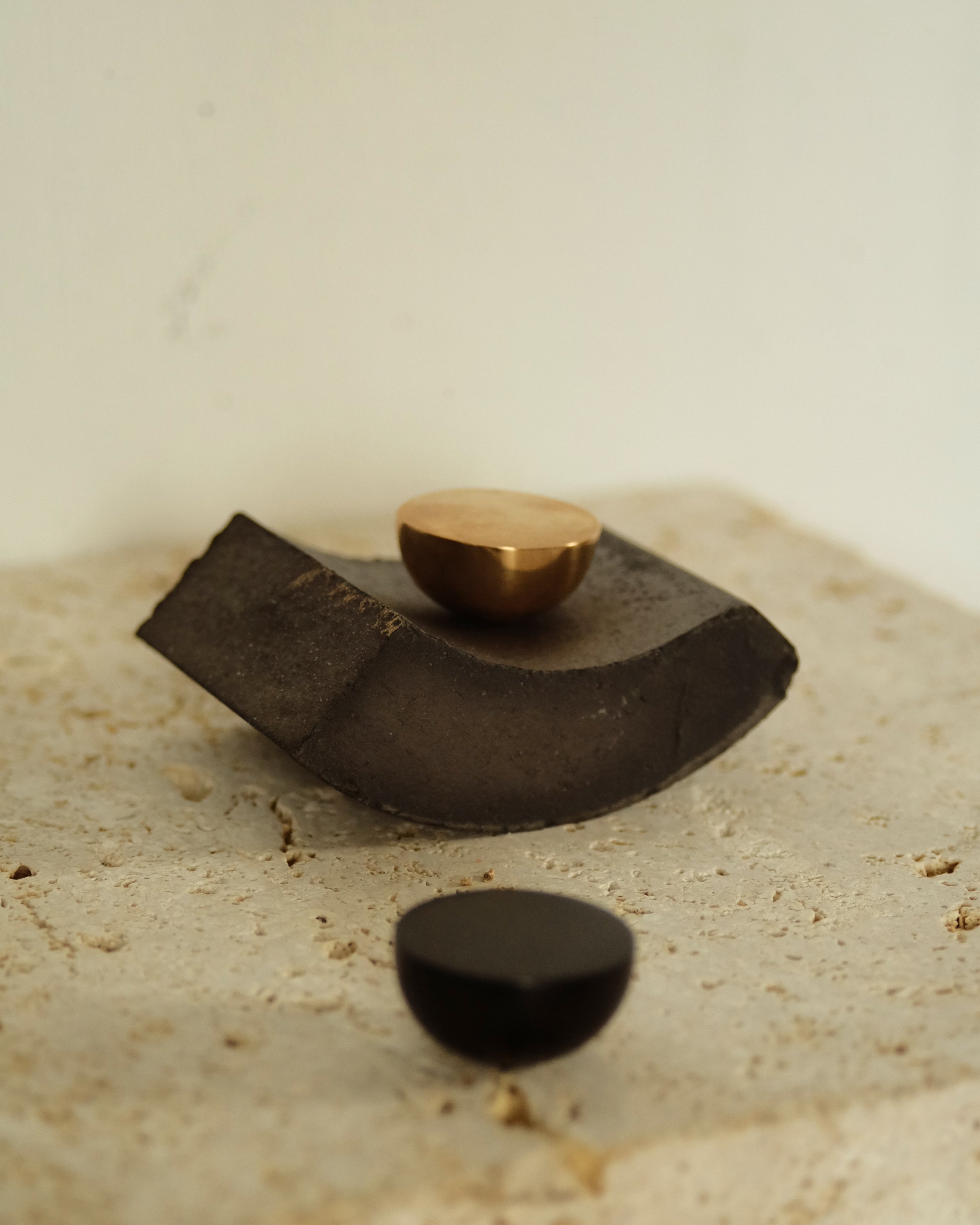 CERCLE Cabinet Knob Half — side angle on textured stone surface