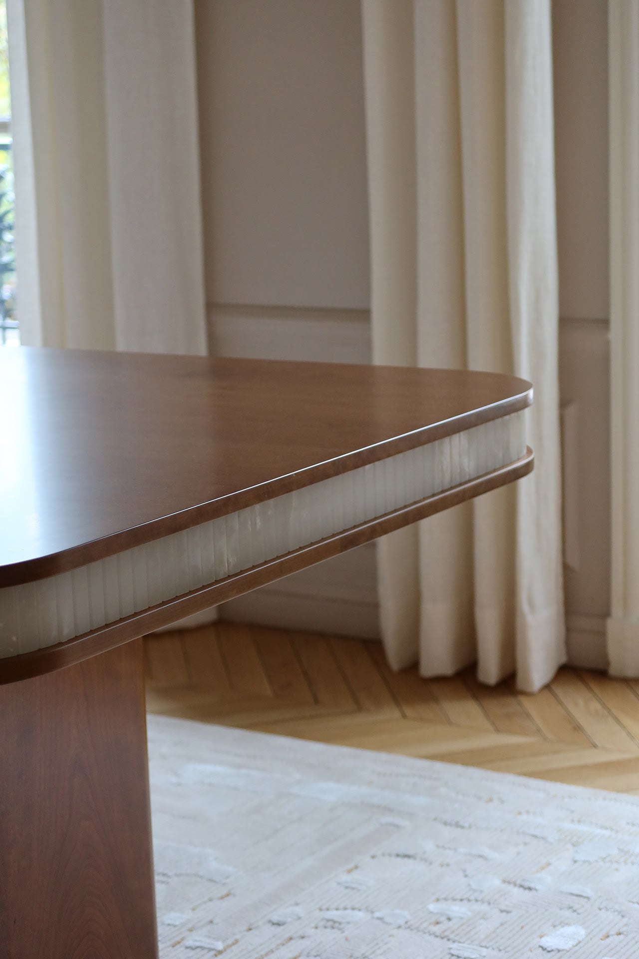 Doppio Wood And White Onyx Dining Table — back view highlighting curved edge and onyx detail