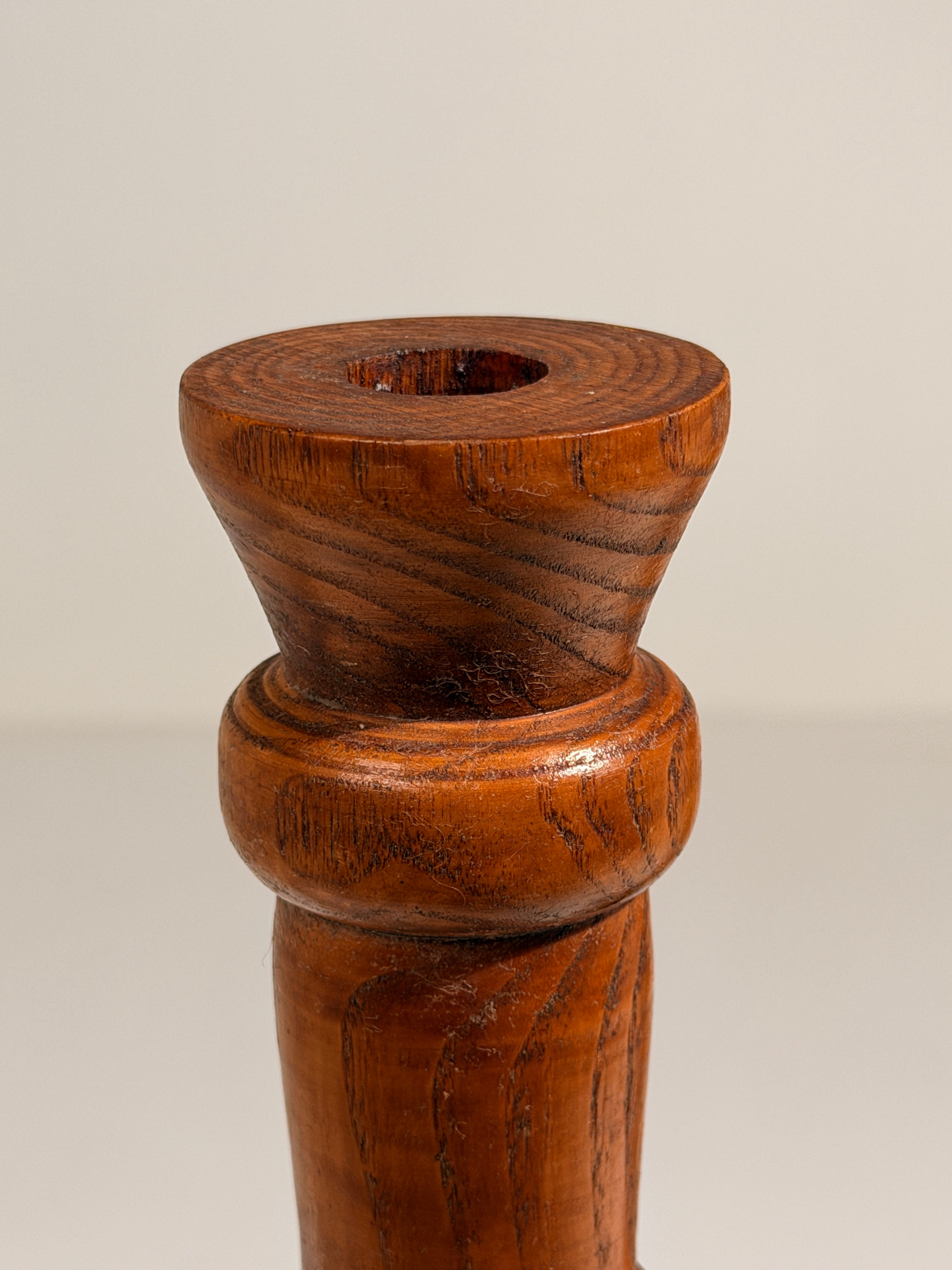 Pair of Brutalist solid wood candlesticks, France, circa 1960 — lifestyle setting