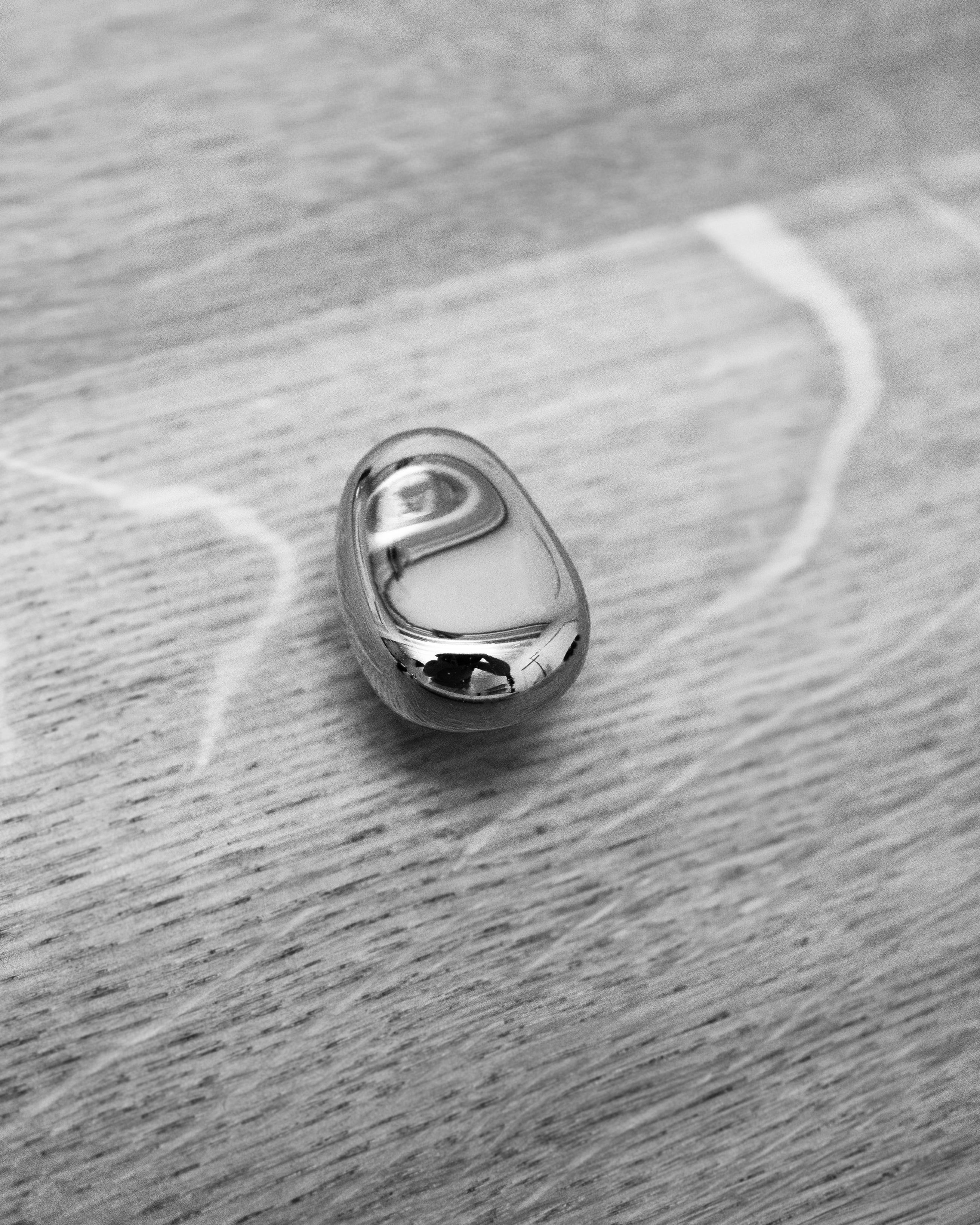 Rud Knob - Titanium — side angle on wooden surface