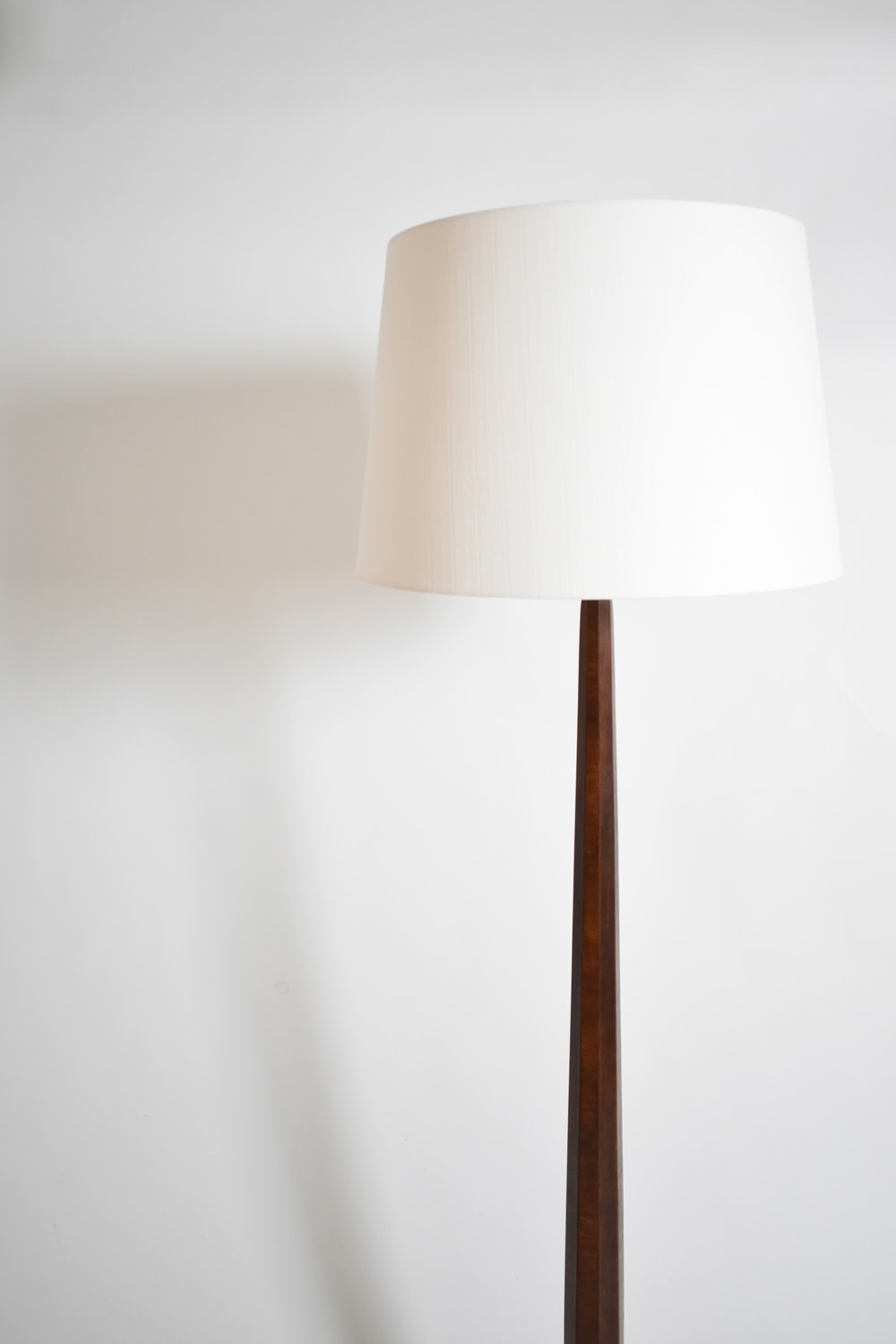 Art deco wooden floor lamp, 1930s — angled view with white shade