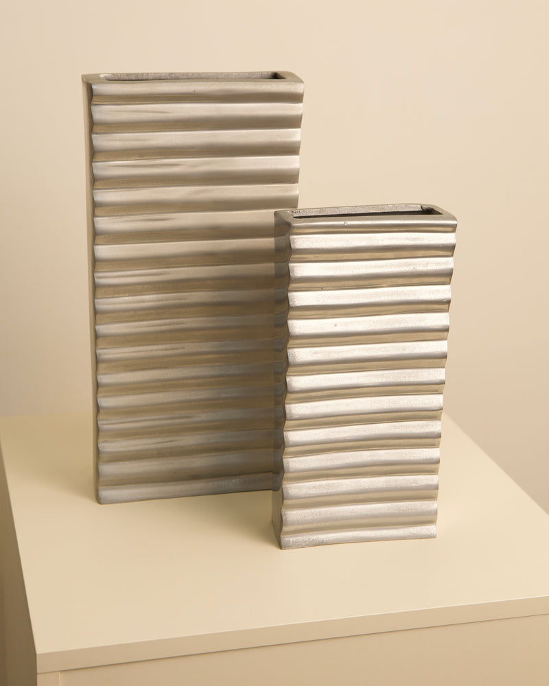 Pair of ribbed aluminum Italian vases with corrugated texture