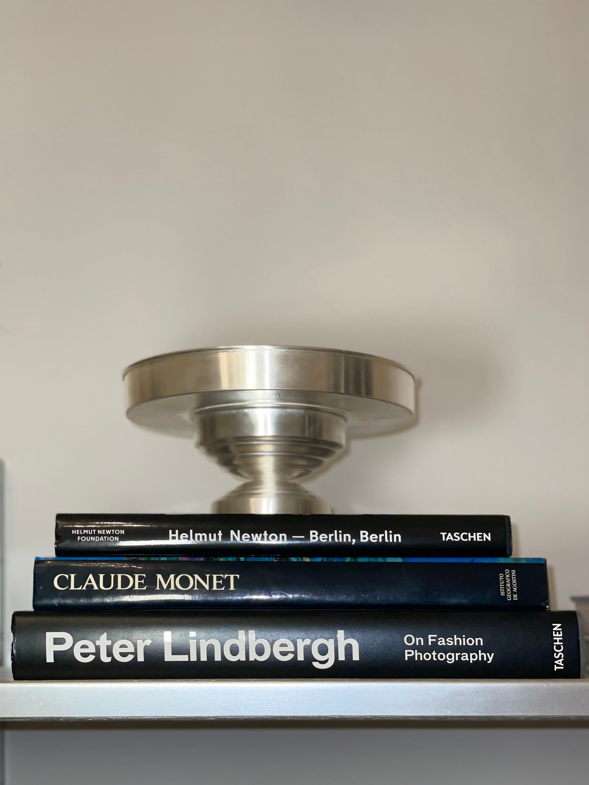 Contemporary Bowl Silver Plated — side angle on stacked art books
