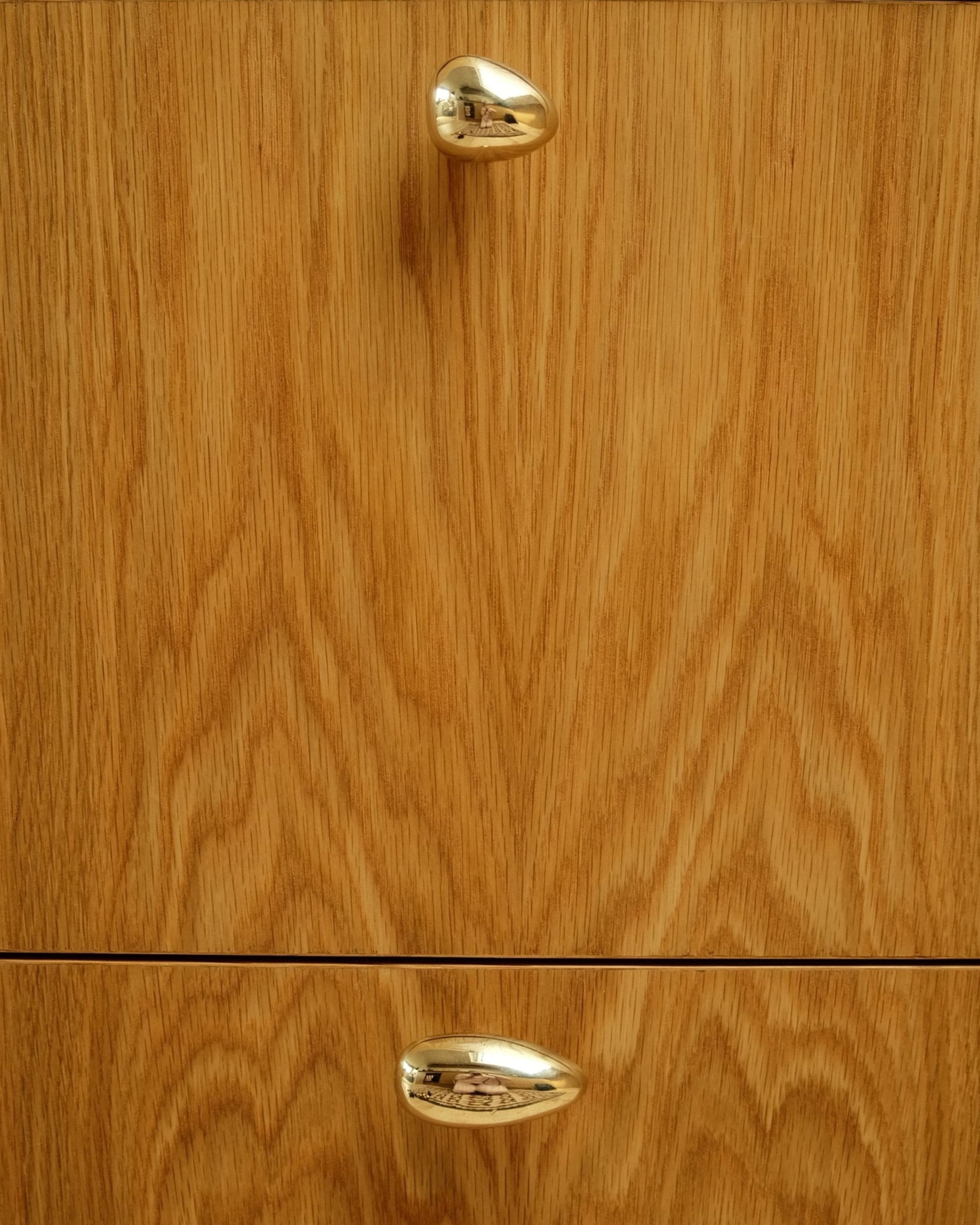 MOMI Cabinet Knob/Wall Hook Short Mini — top view of brass knob on oak cabinet