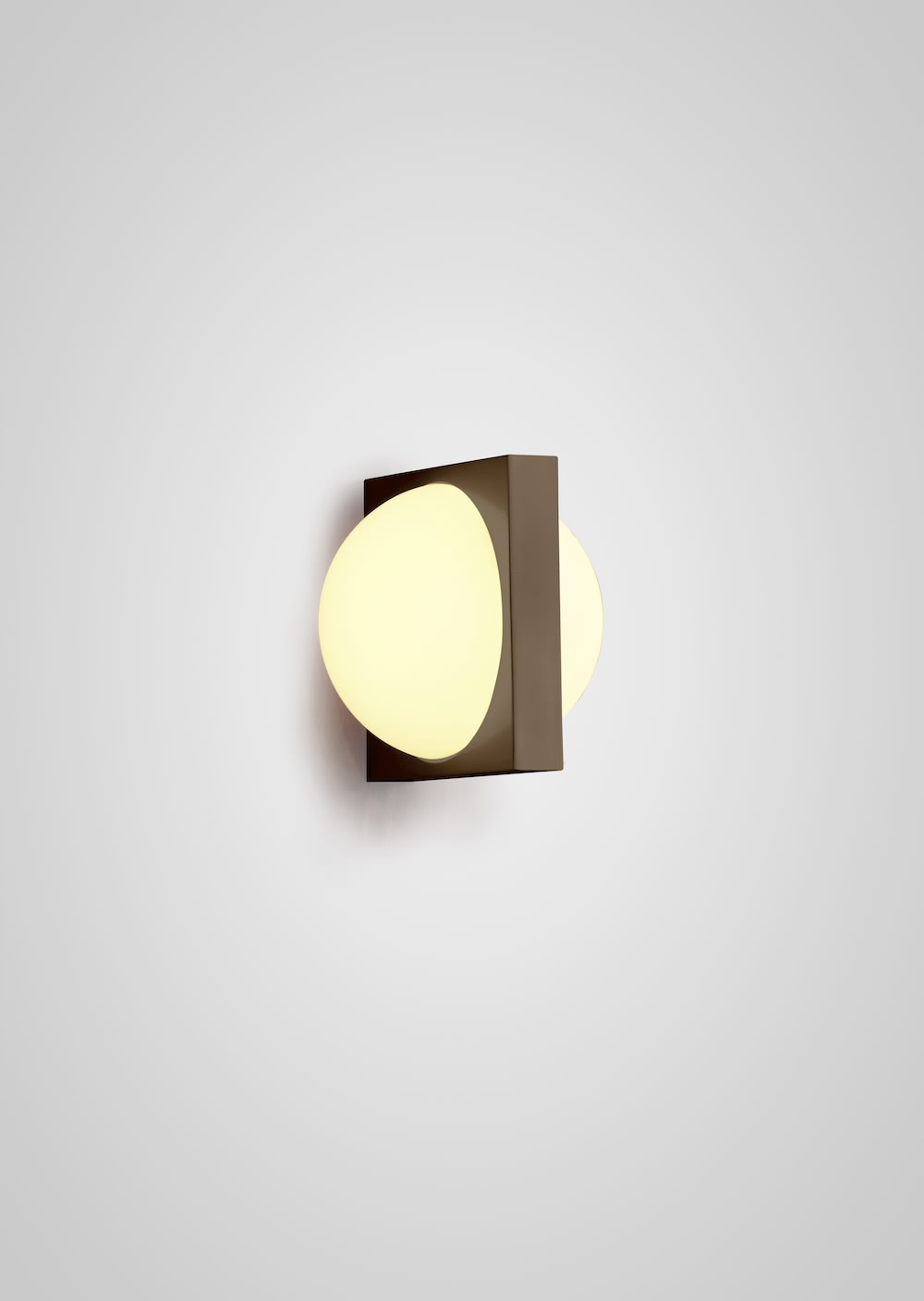 Solstice Wall Light — side view showing white glass and metal base
