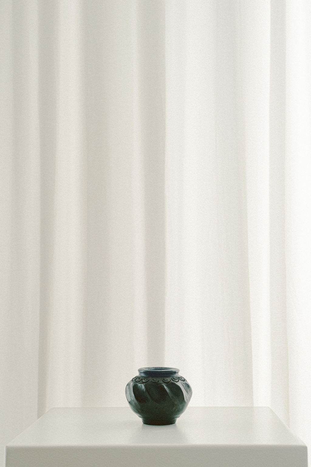 Indian Miniature Bronze Vessel — close-up of dark bronze texture on white pedestal