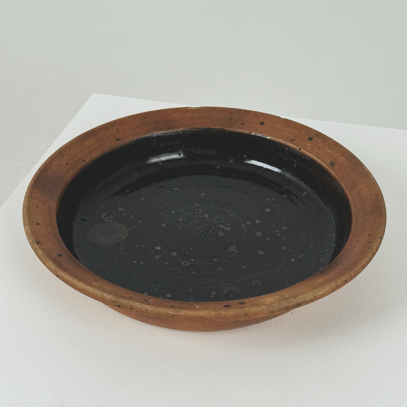 Interior view of Pierre Digan stoneware bowl with dark glaze