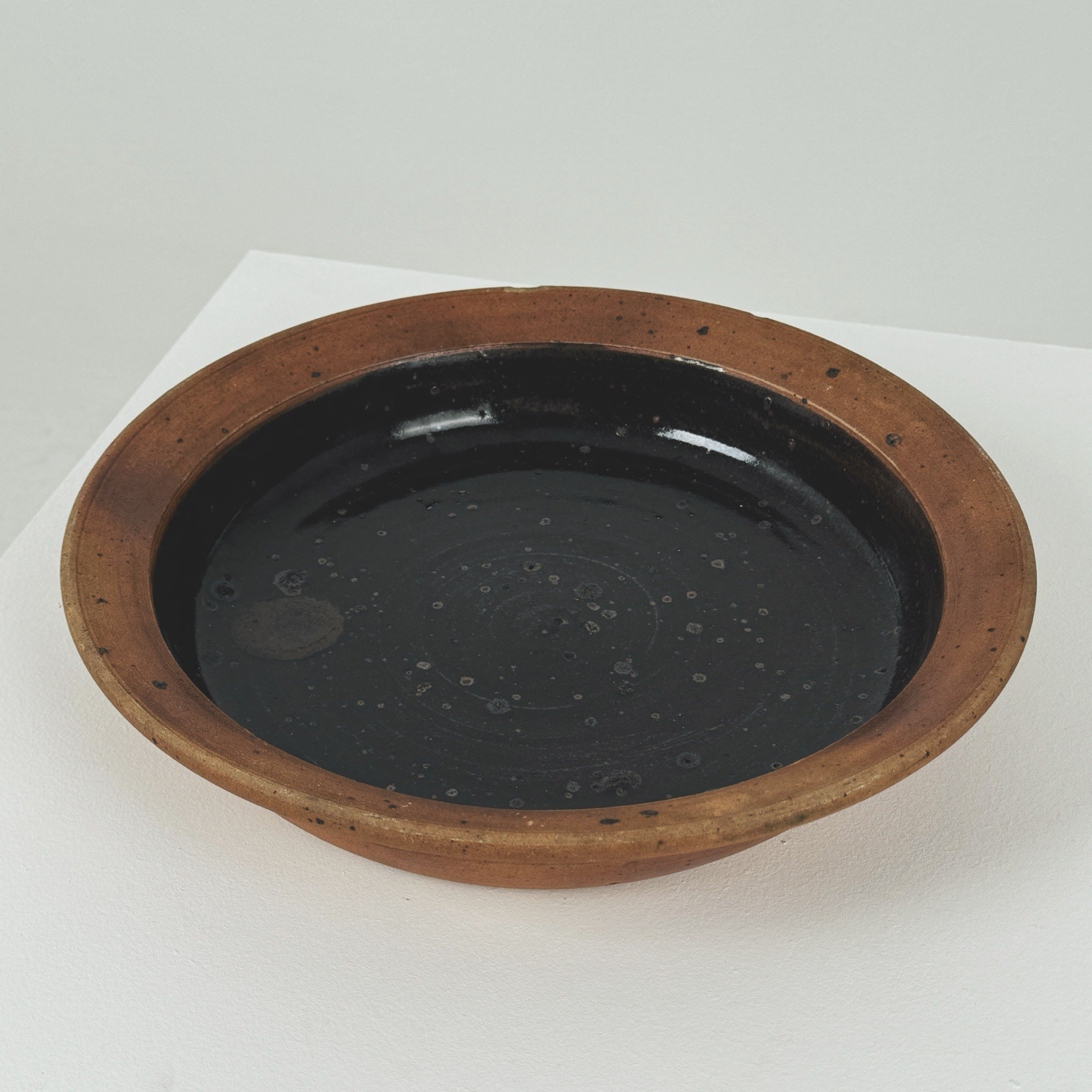 Interior view of Pierre Digan stoneware bowl with dark glaze