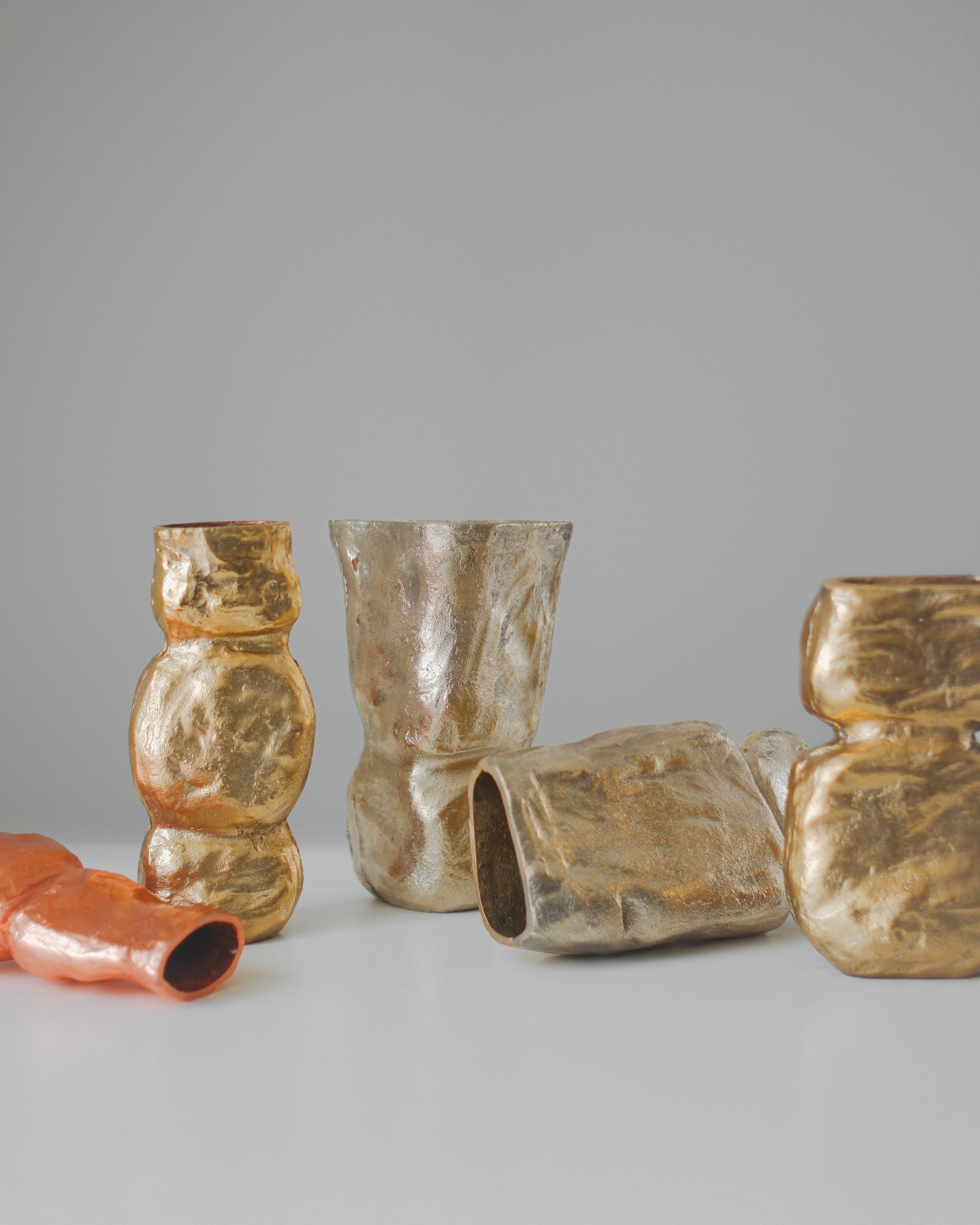 OLIO Vase No. 4 — group of metallic vases on white surface