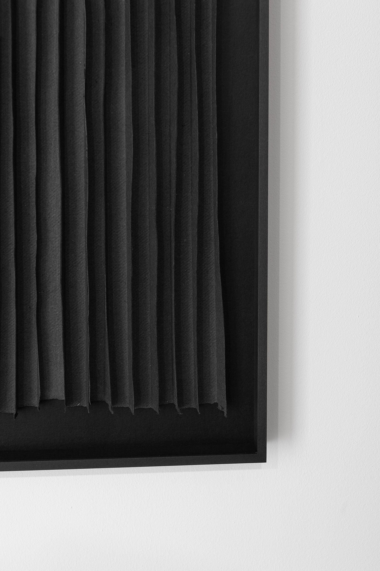 Close-up detail of black vertical paper strips in geometric composition