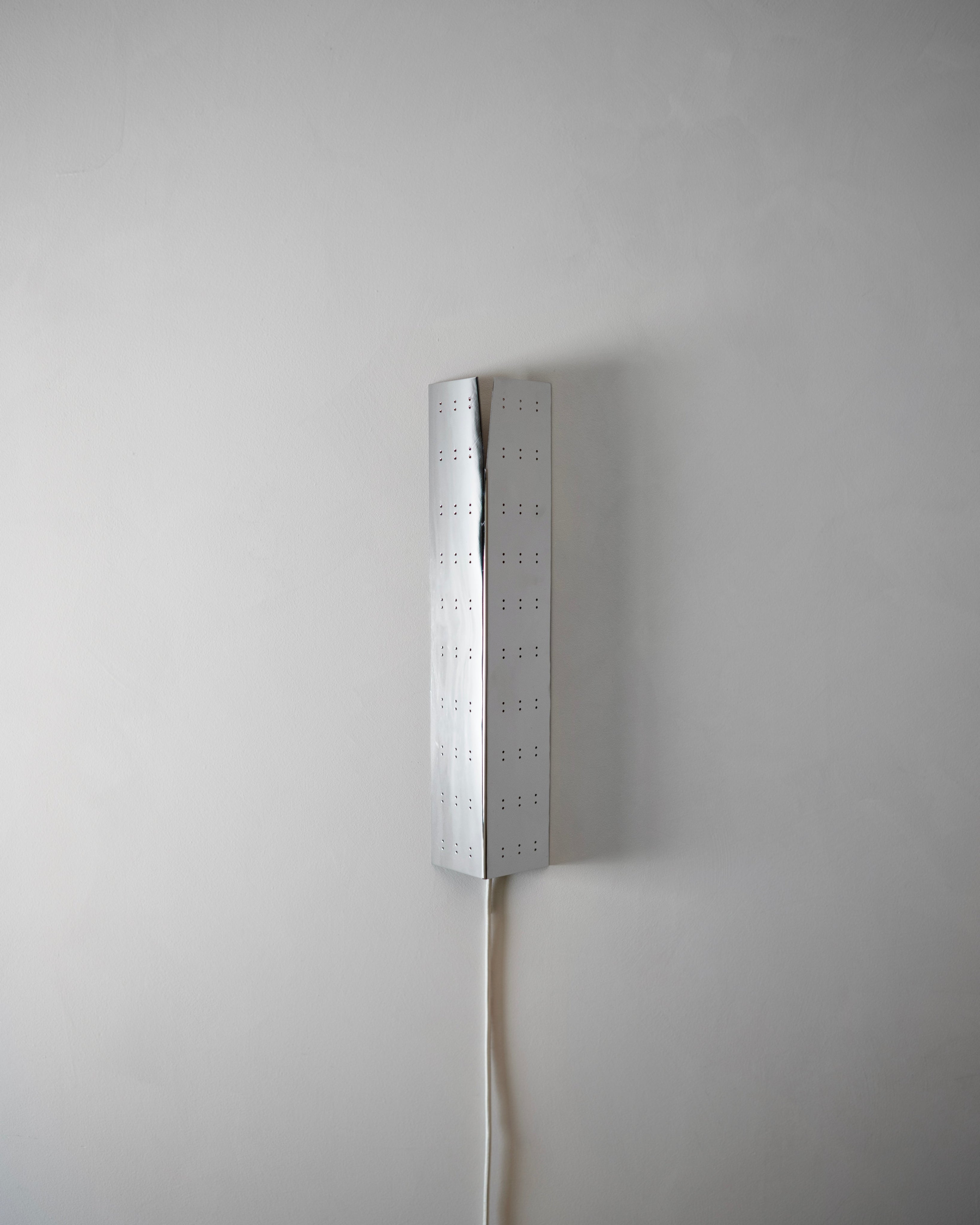 May Wall Lamp - Polished Steel — top view showing perforated metal design