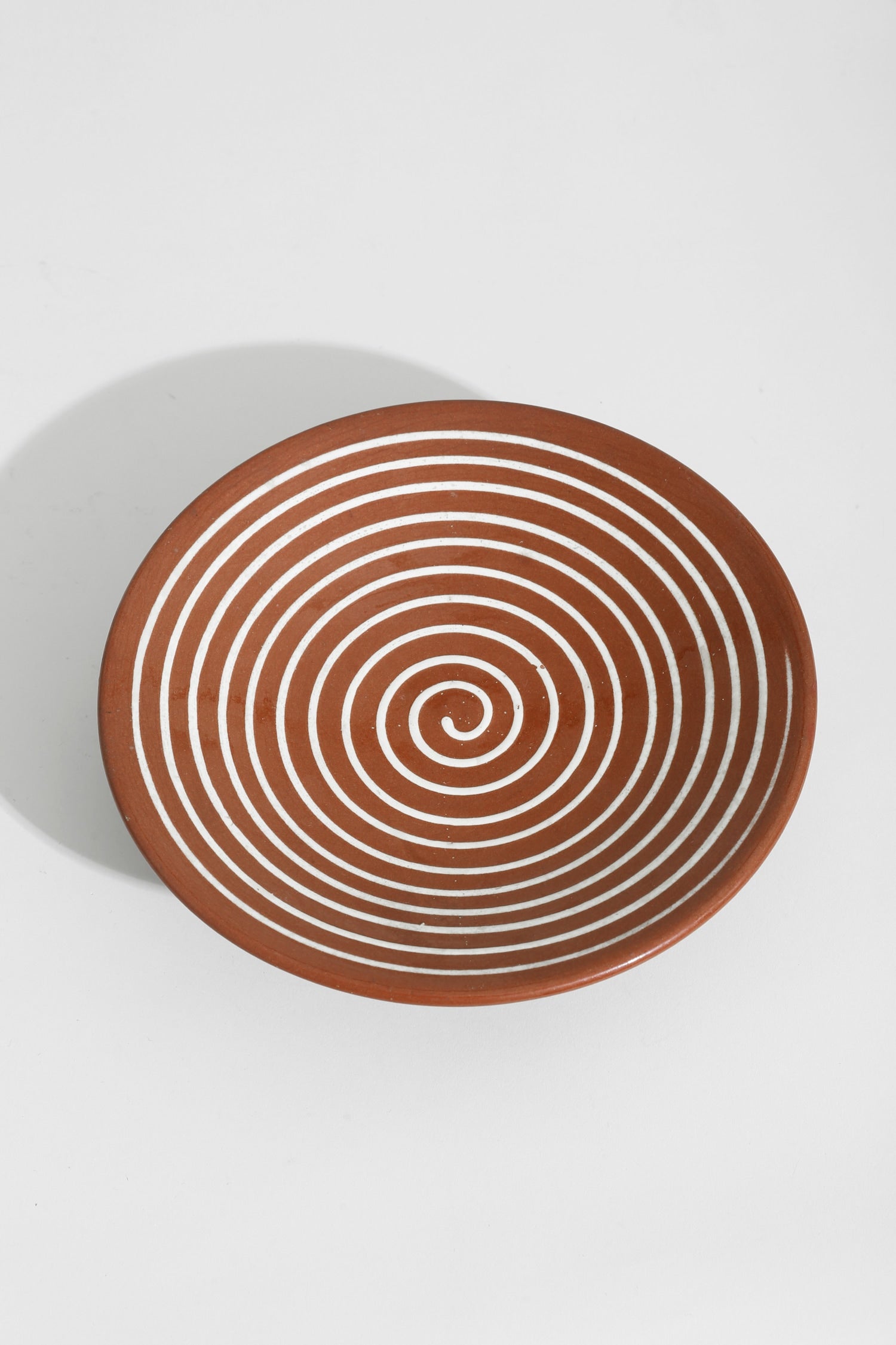 Spiral Pedestal Pottery Bowl — top view of terracotta with white spiral design