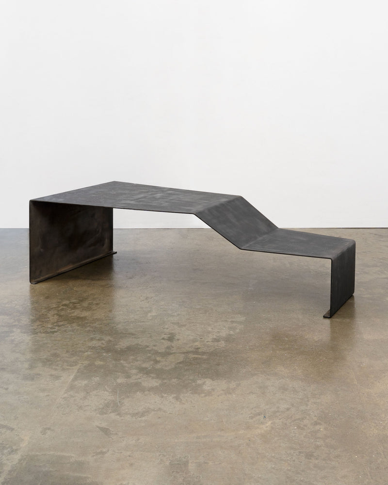 Large patinated steel bench coffee table with curved design