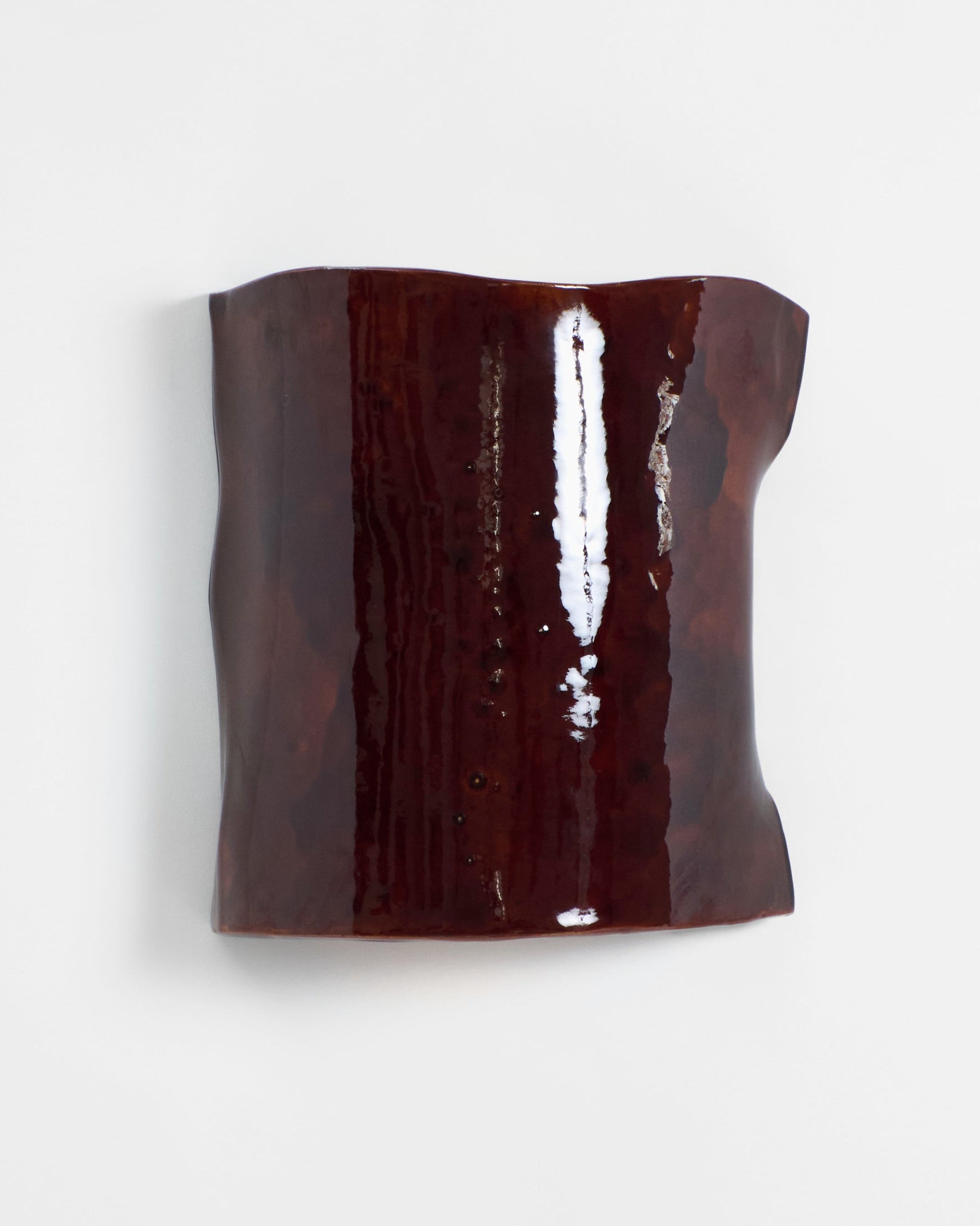 Papel Wall Light — close-up of dark brown ceramic surface