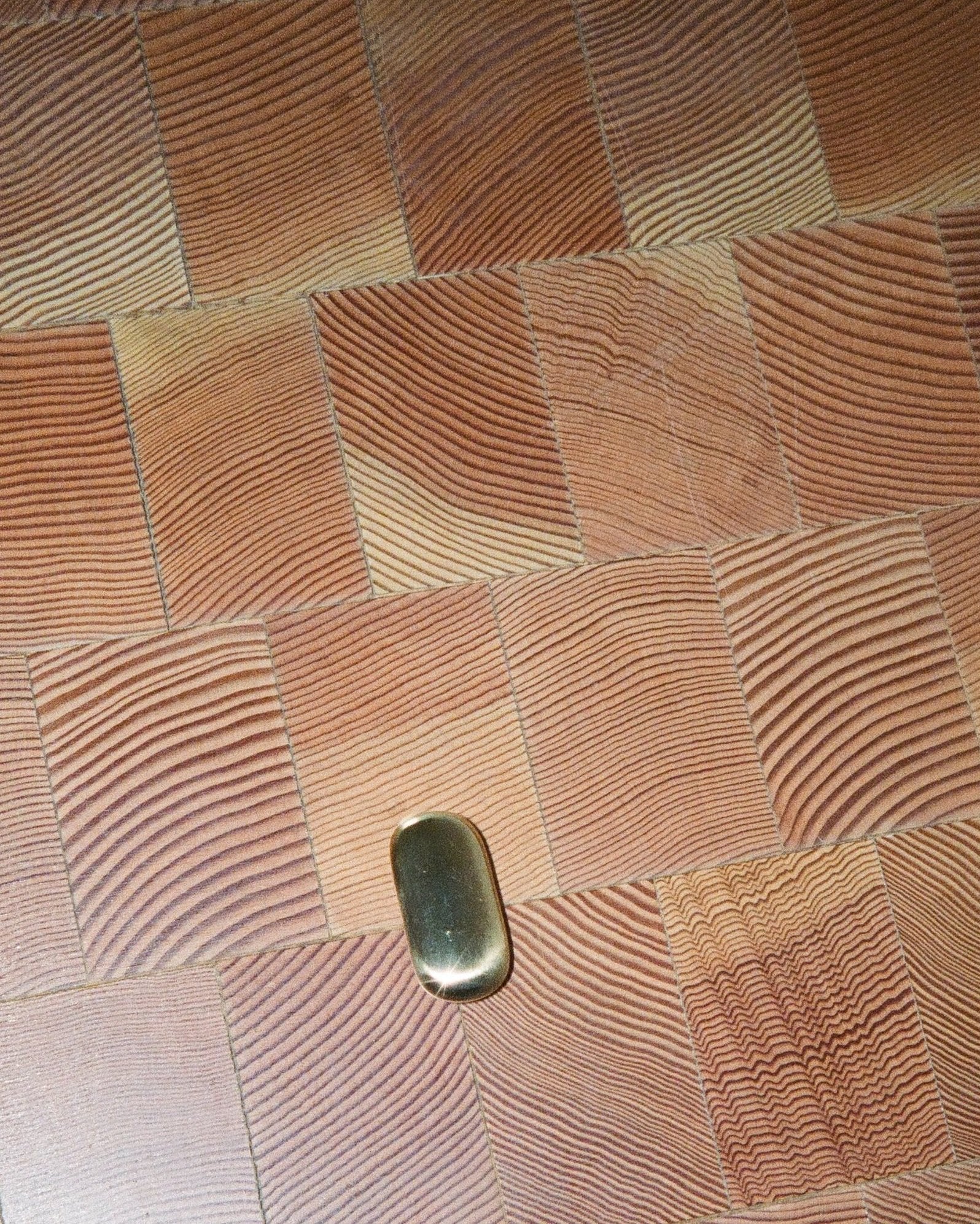 OVAL Cabinet Knob/Wall Hook — close-up of brass knob on wood surface