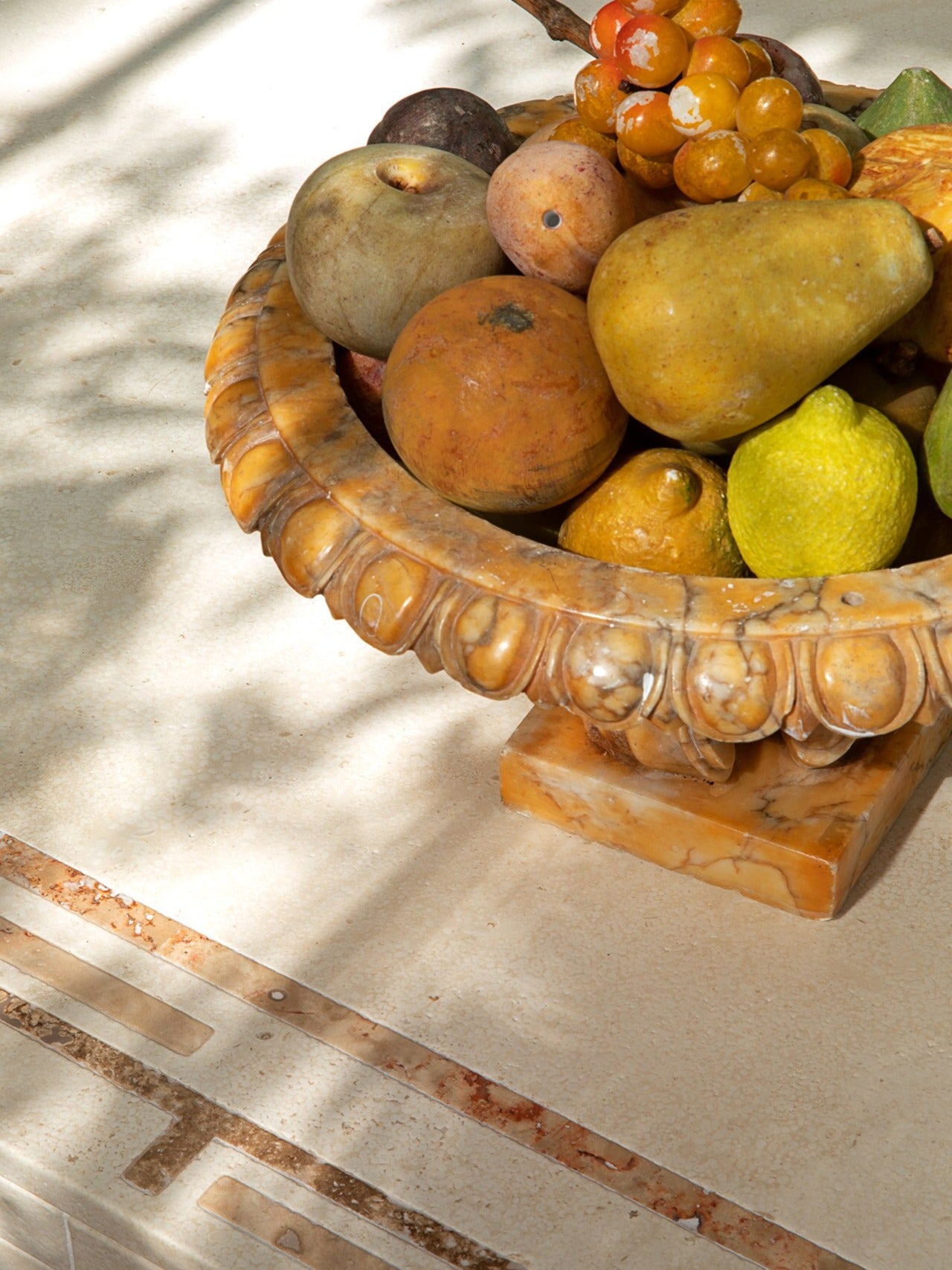 Greek Symposia Dining Table — marble surface with fruit bowl centerpiece