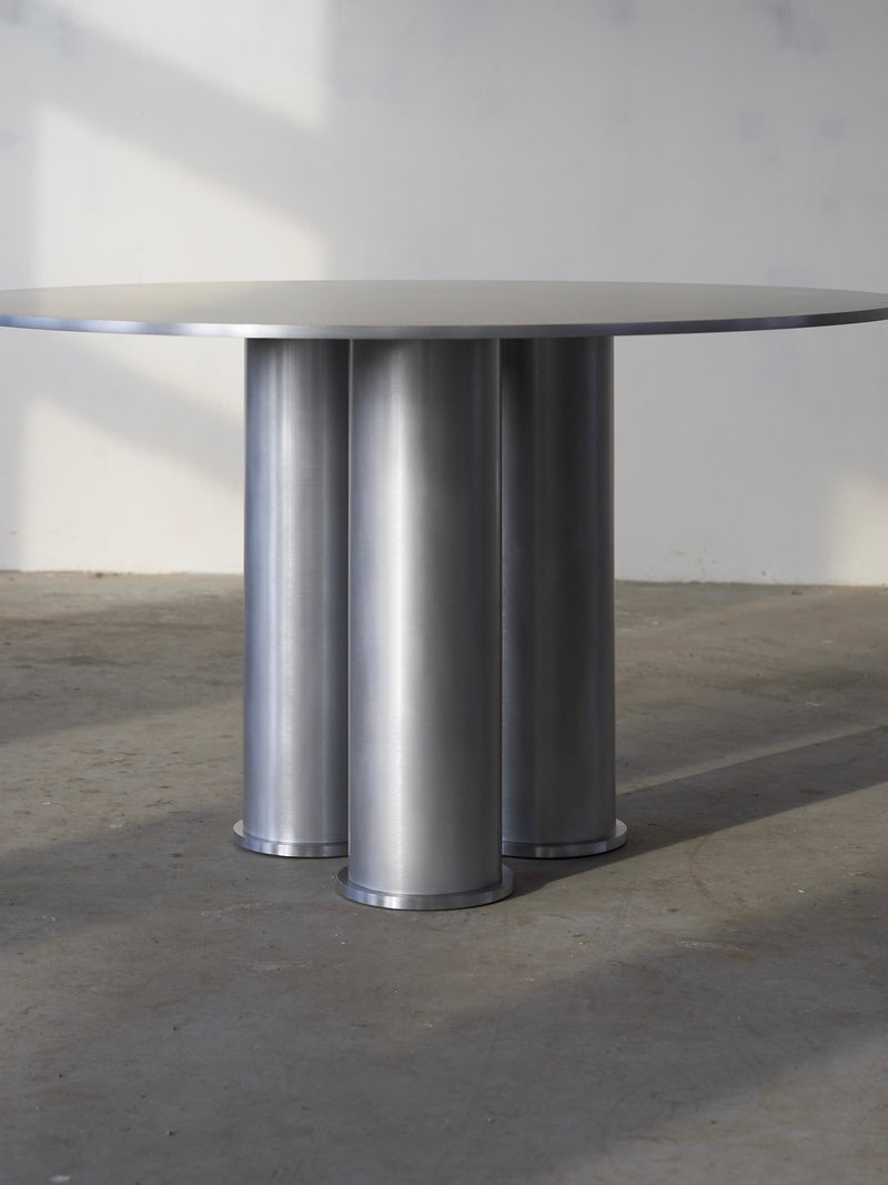 Elephant Table (Dining) — close-up of brushed metal surface and cylindrical legs