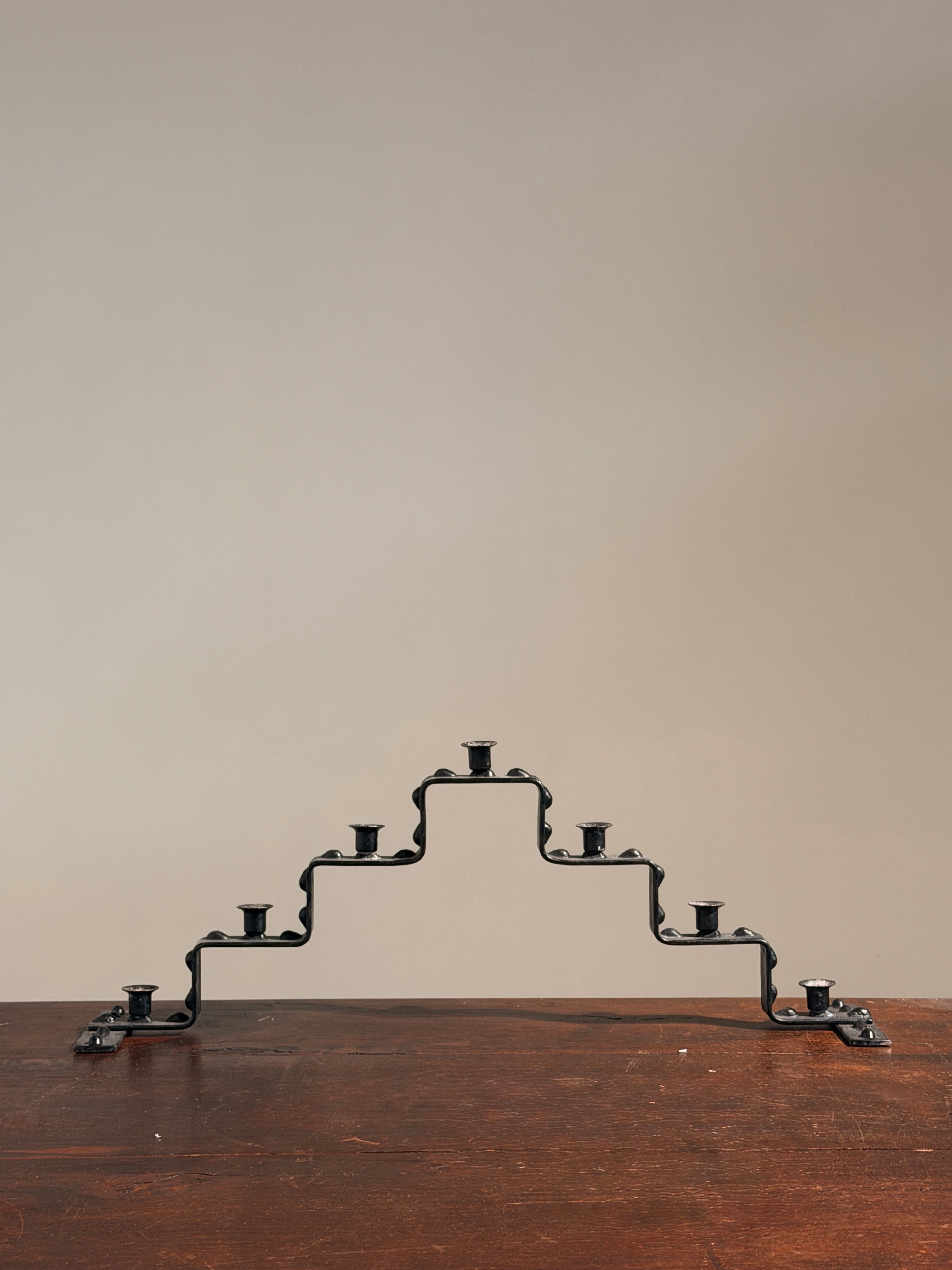 Seven-light geometric candelabra in black iron, circa 1960 — detail view
