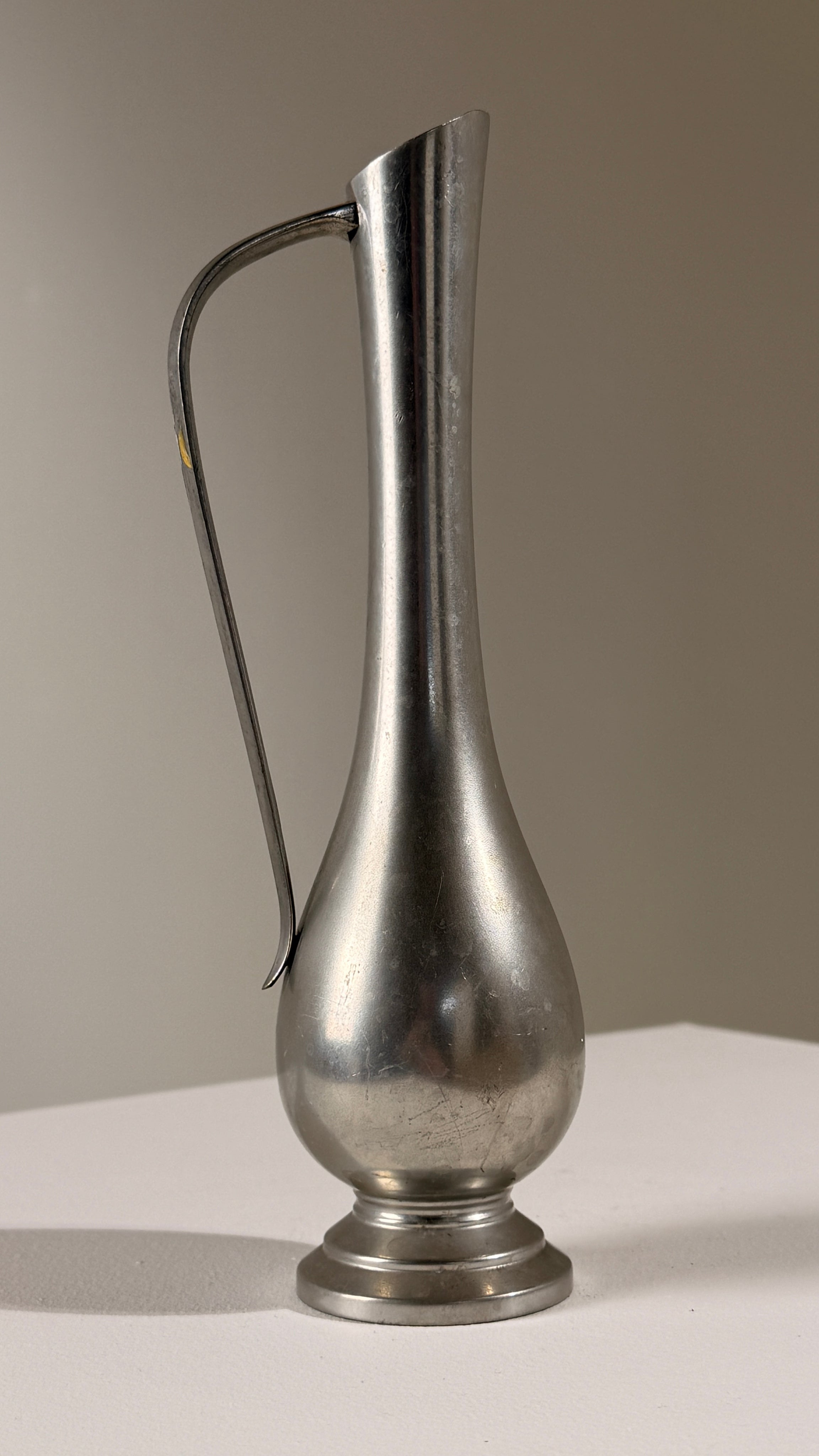 Pewter Pitcher, Paris, France, circa 1930 — angled view on white surface