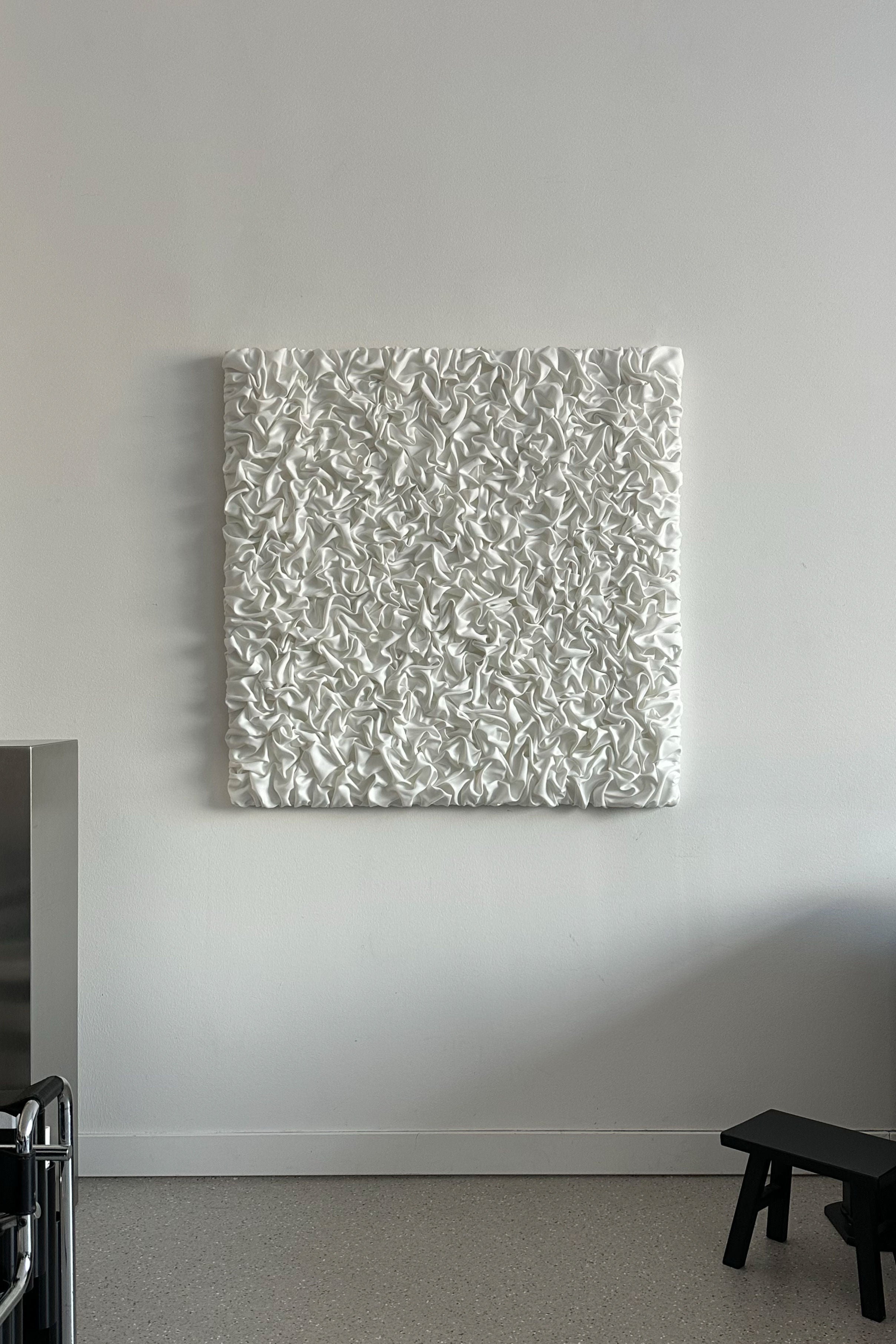 ESCAPISM 108' sculptural wall art — side view against white wall