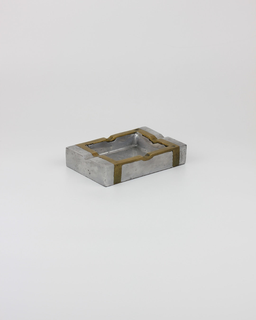 Brutalist Ashtray — angled view of concrete and brass design