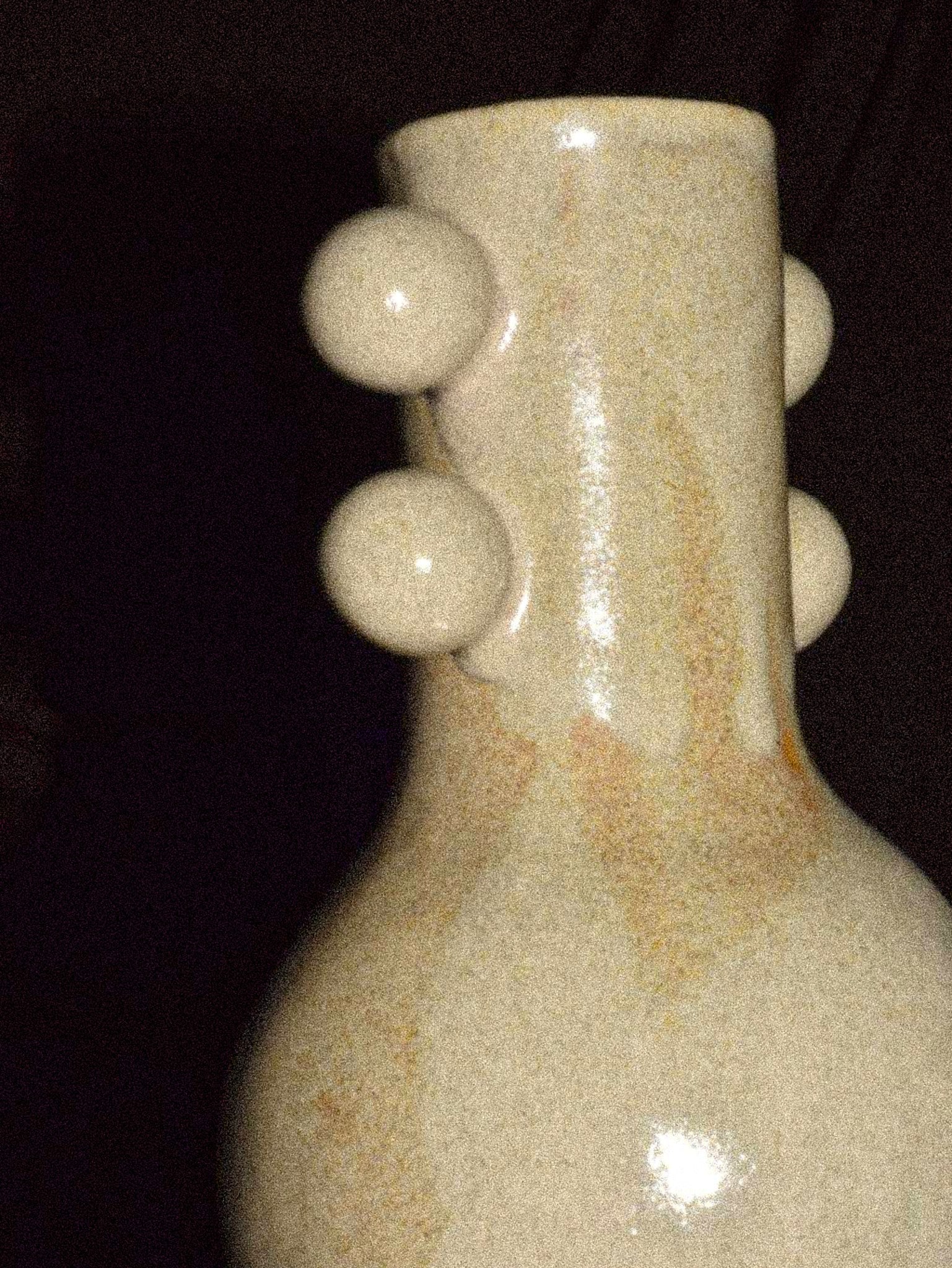 Long Neck Vase — side angle highlighting ceramic texture and round accents