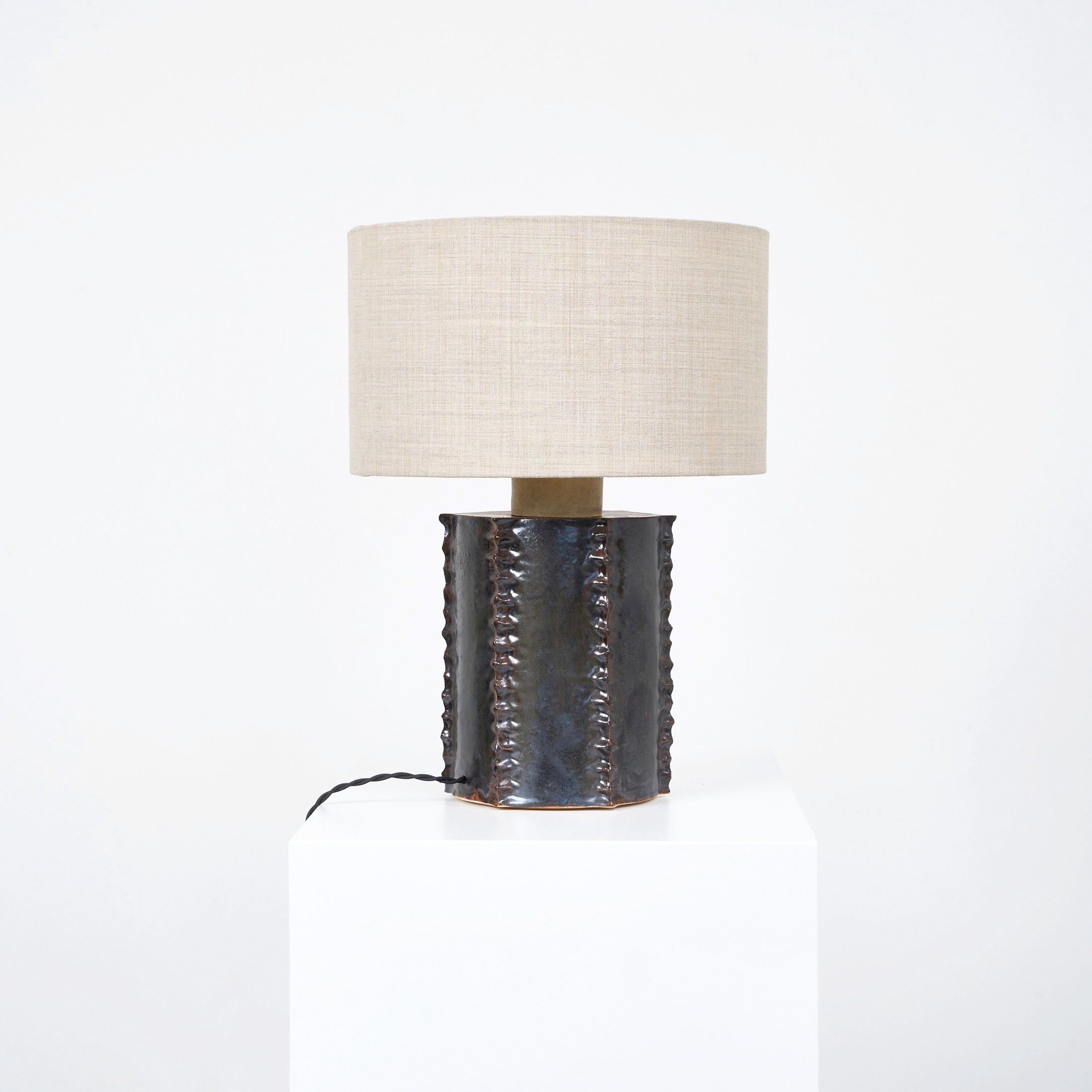 Totem Table Light — close-up of textured ceramic base with linen shade
