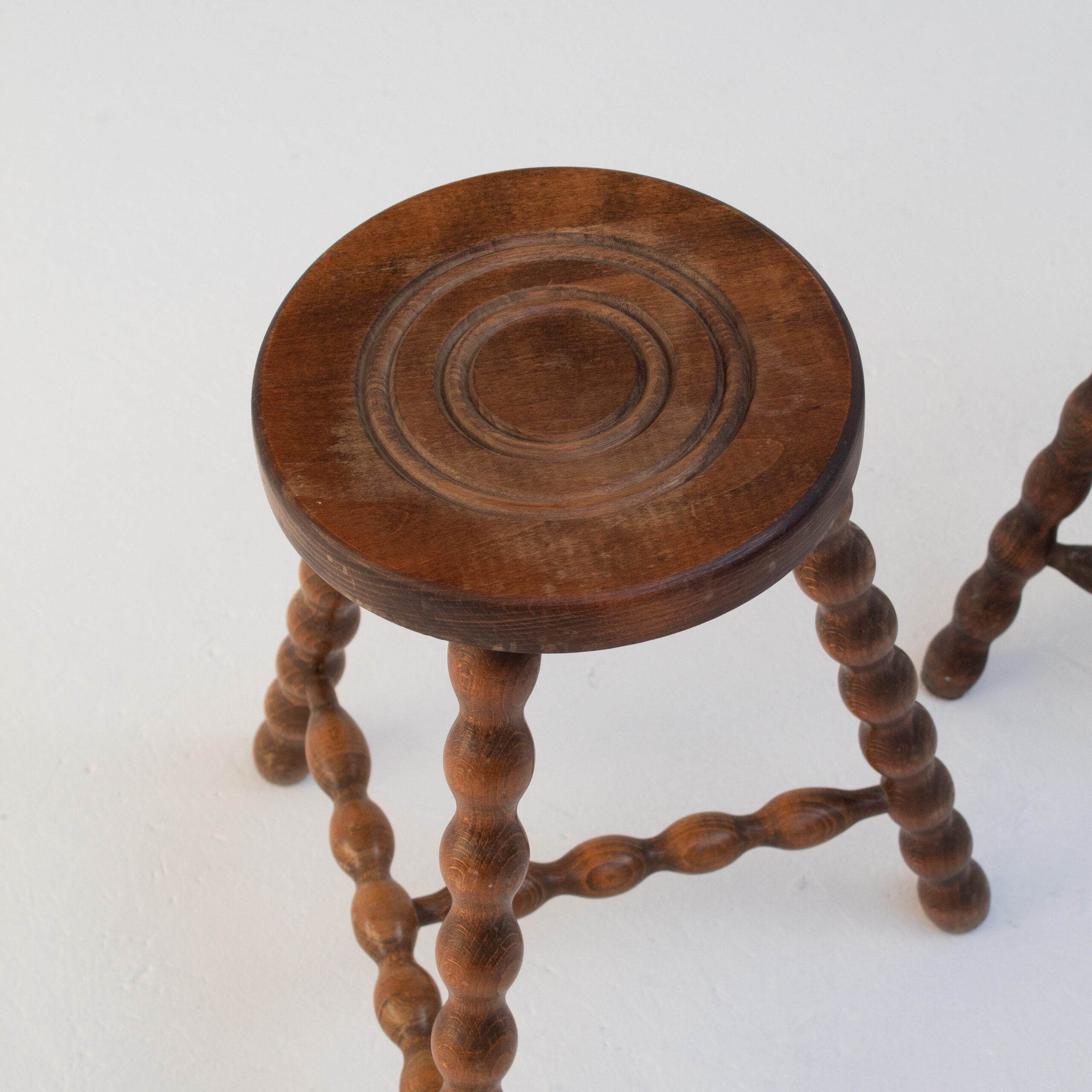 Pair of Vintage Wooden Bobbin Stools — top view of carved wooden seat