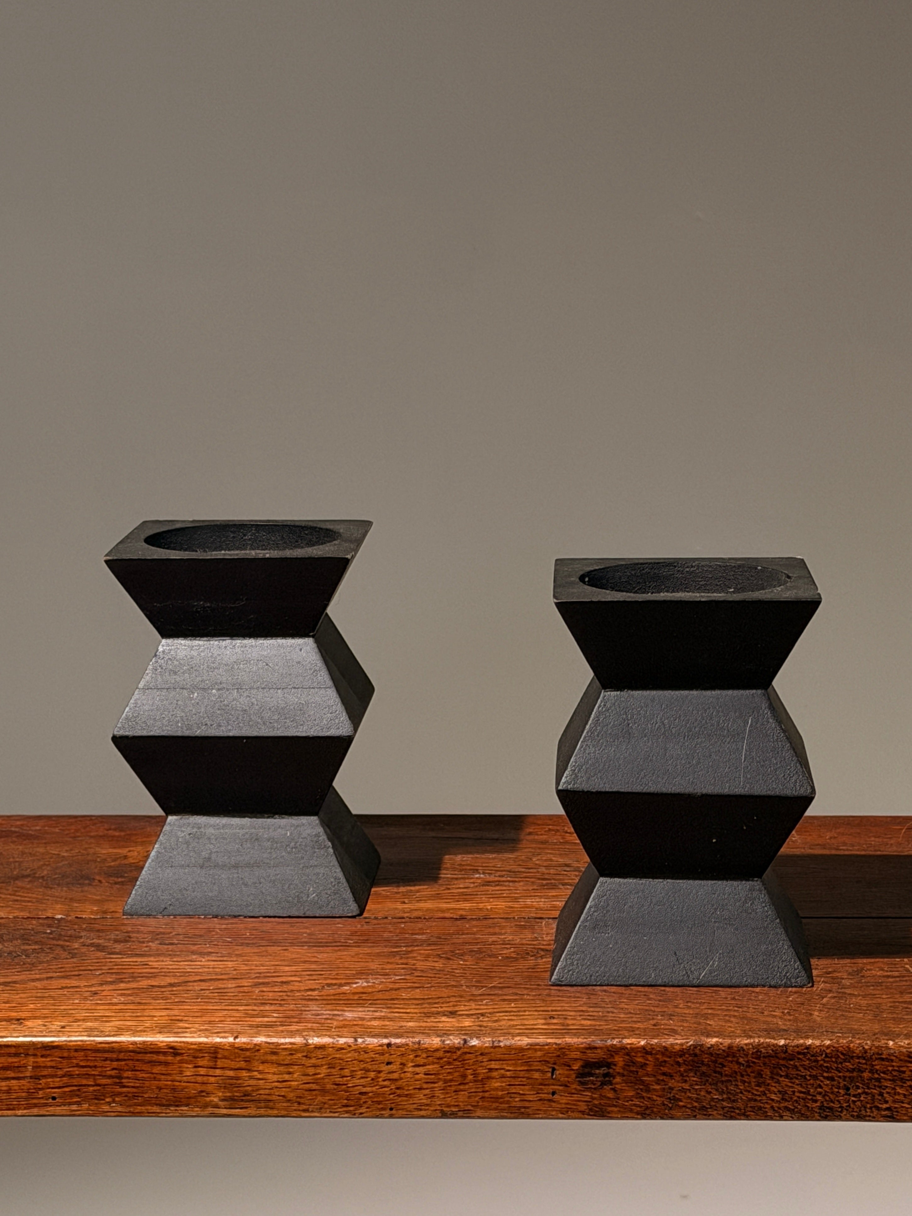 Pair of geometric black wooden candlesticks, anonymous work by Figuresdesign | The Oblist