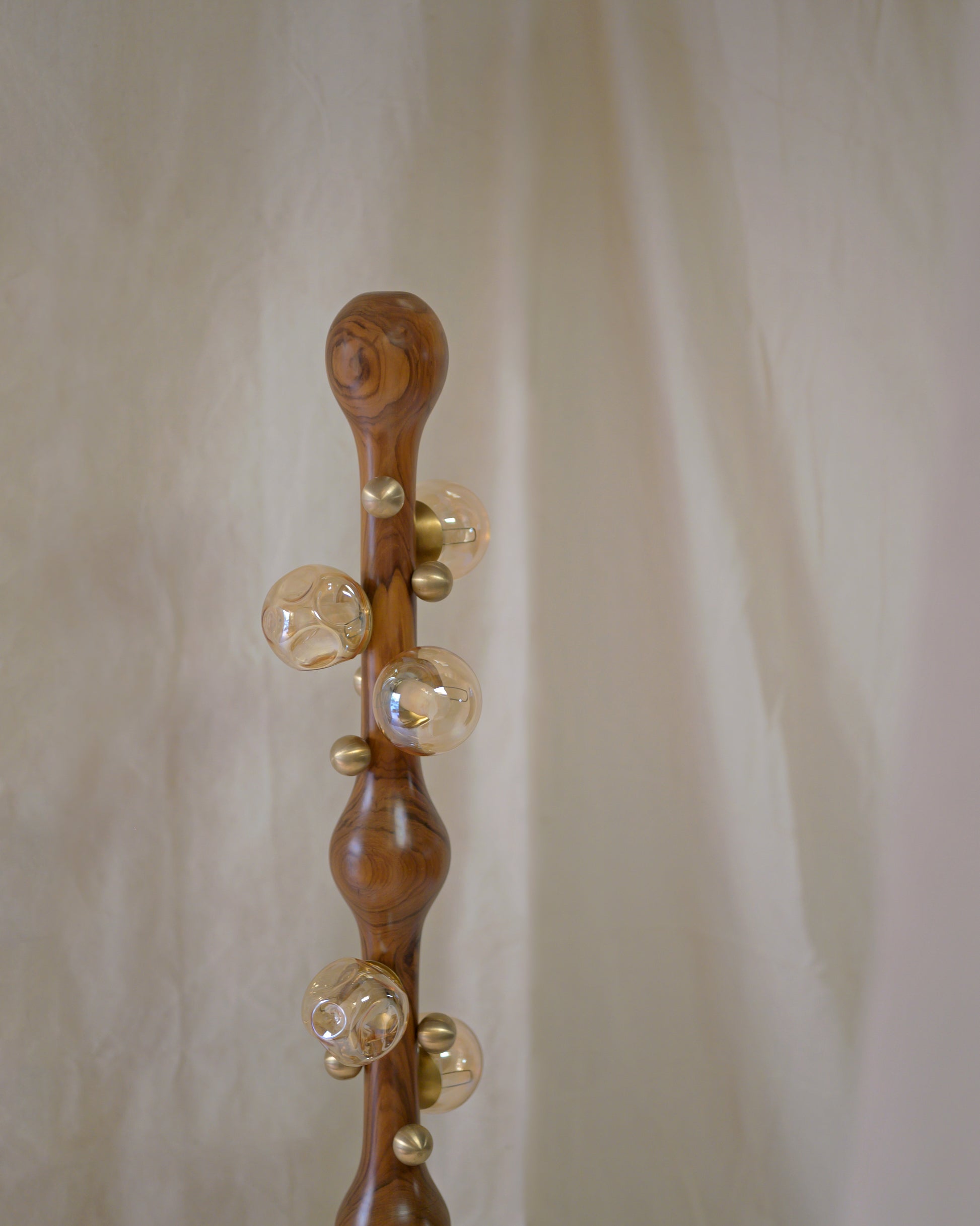 Stem Floor Lamp — top view of wooden stem with glass orbs