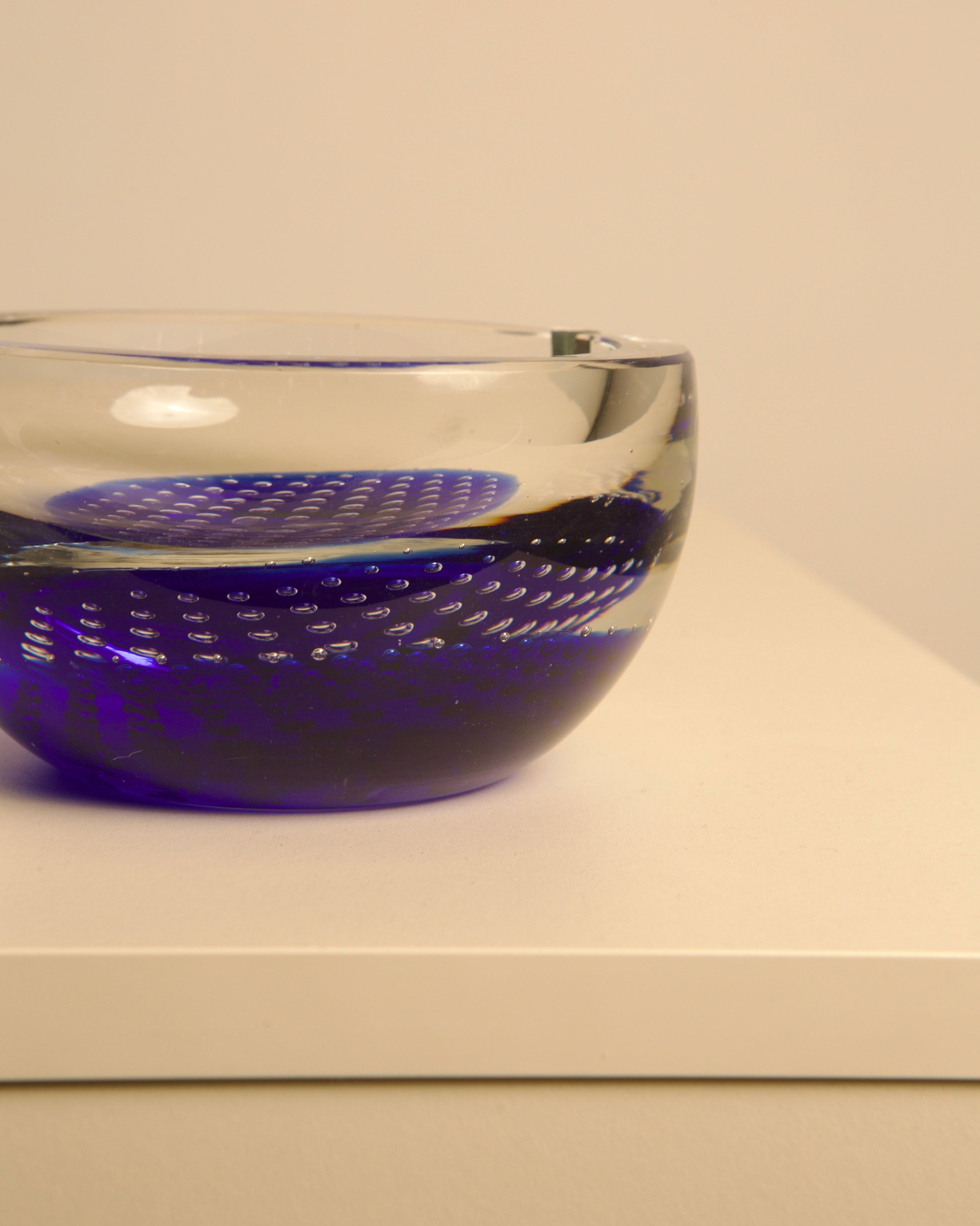 Close-up detail of blue Murano glass ashtray with bubble pattern