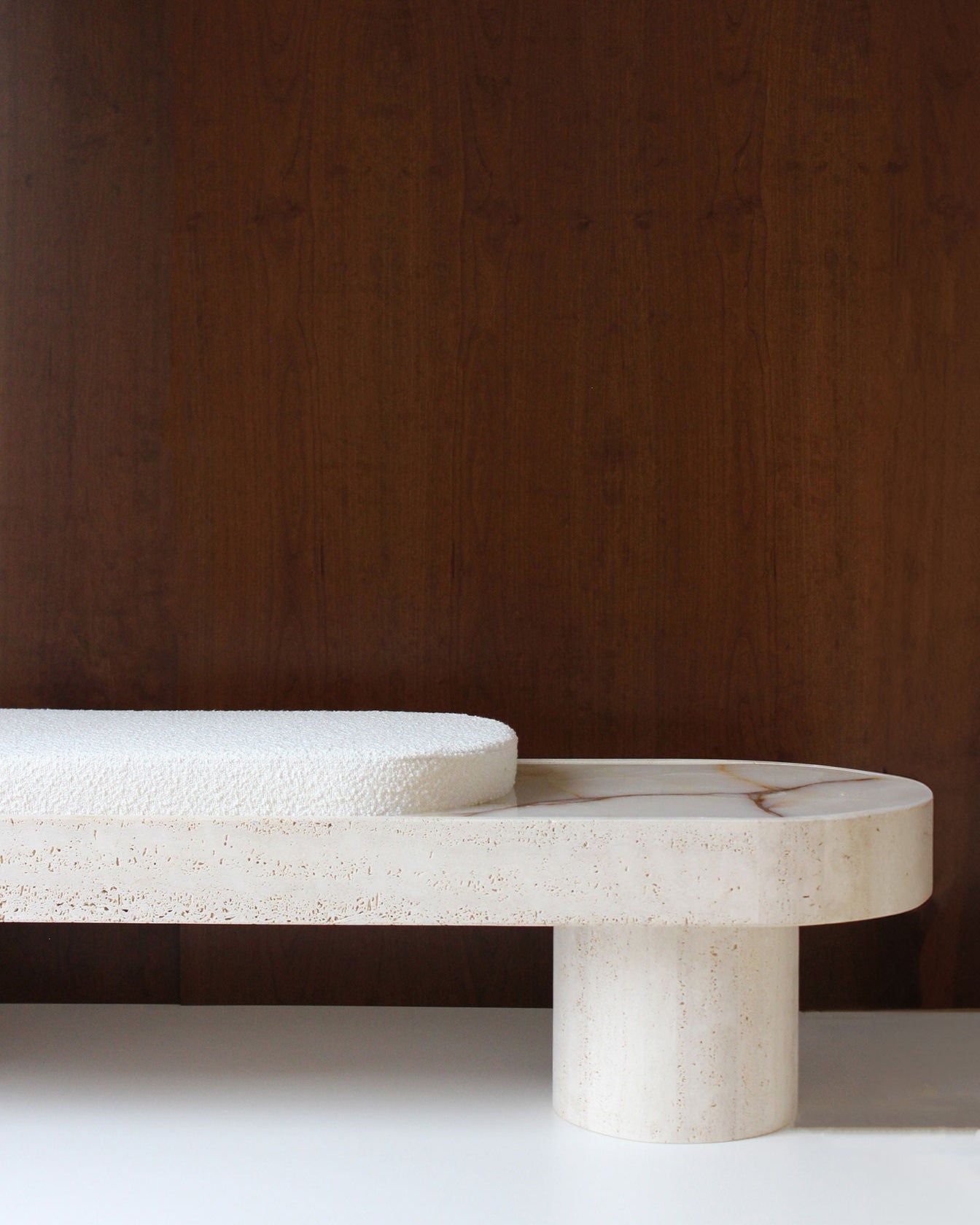 Noto Bench — side view of textured stone base with white cushion